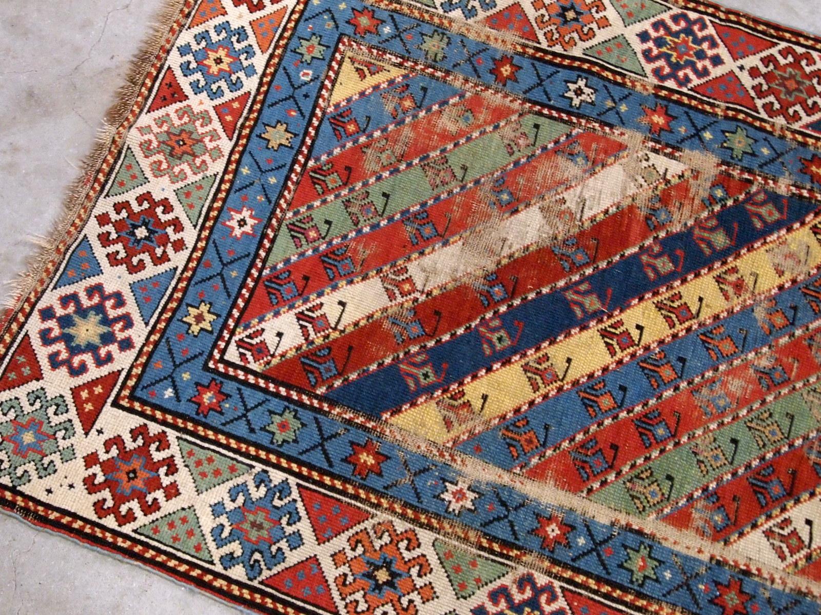 Handmade antique Caucasian rug in distressed condition, from the end of 19th century.
 