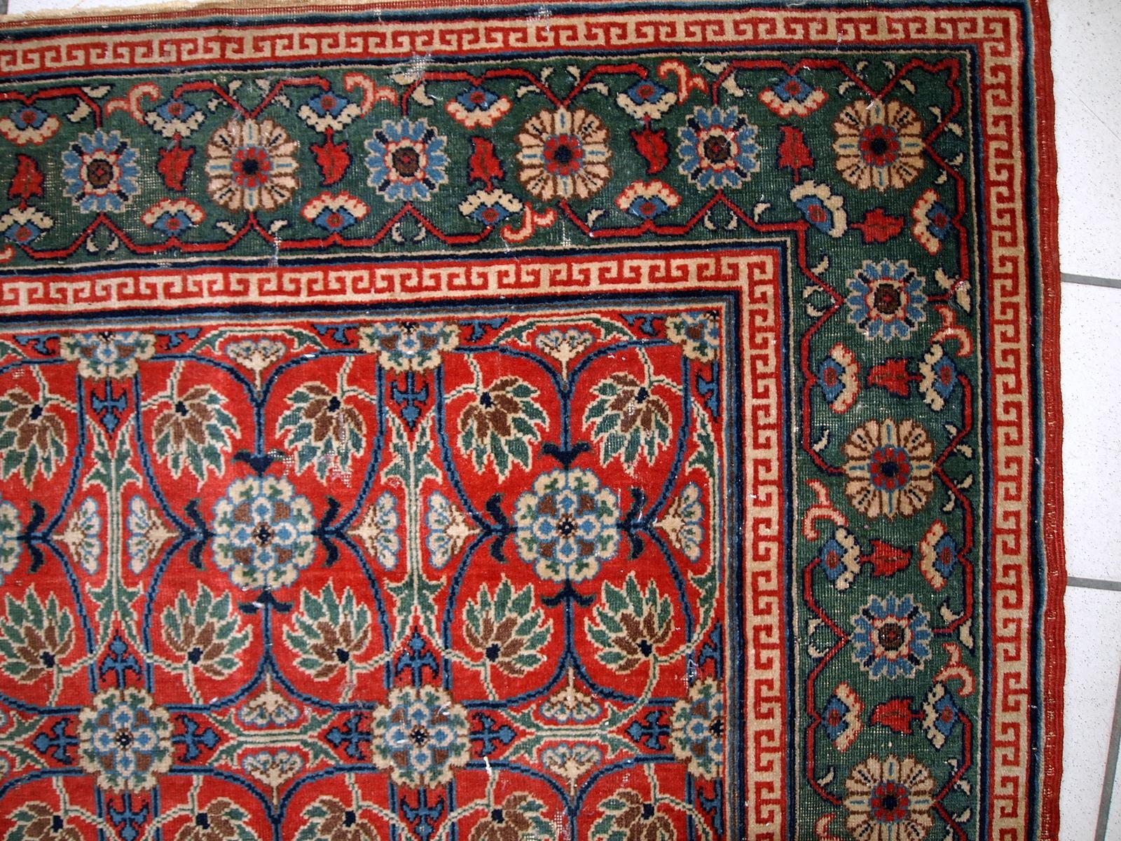 Handmade antique East Turkestan distressed rug with repeating pattern. It is in red and green shades, made in the beginning of 20th century.

-condition: distressed,

-circa: 1900s,

-size: 3.5' x 5.1' ( 107cm x 156cm ),

-material: