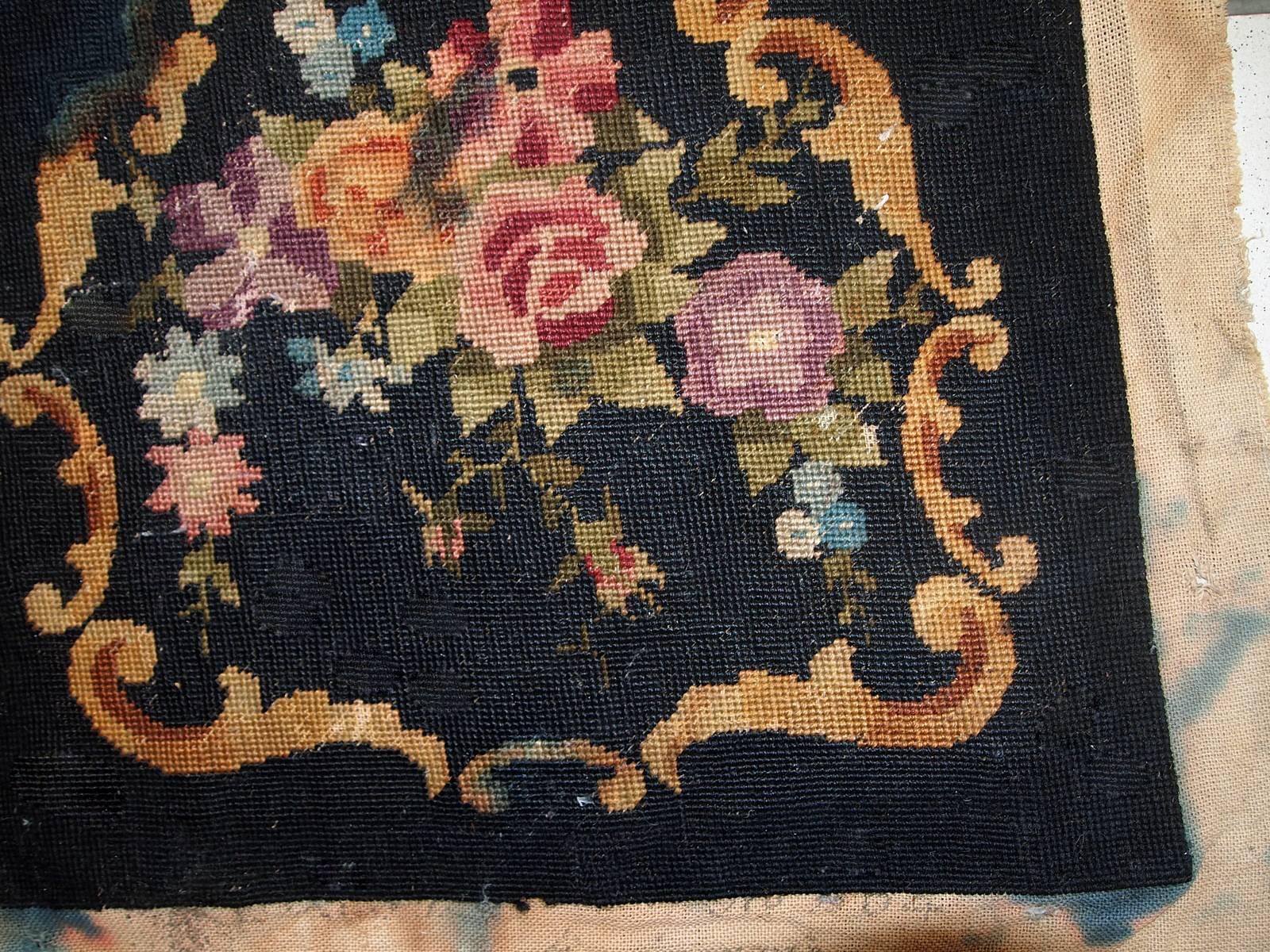 Handmade antique unframed English needlepoint in black color with floral design. The size of actual needlepoint is 1.3' x 1.4' (42cm x 45cm) and with the sides is 2' x 2.2' (63cm x 68cm). It is in original condition, it has some discolorations on