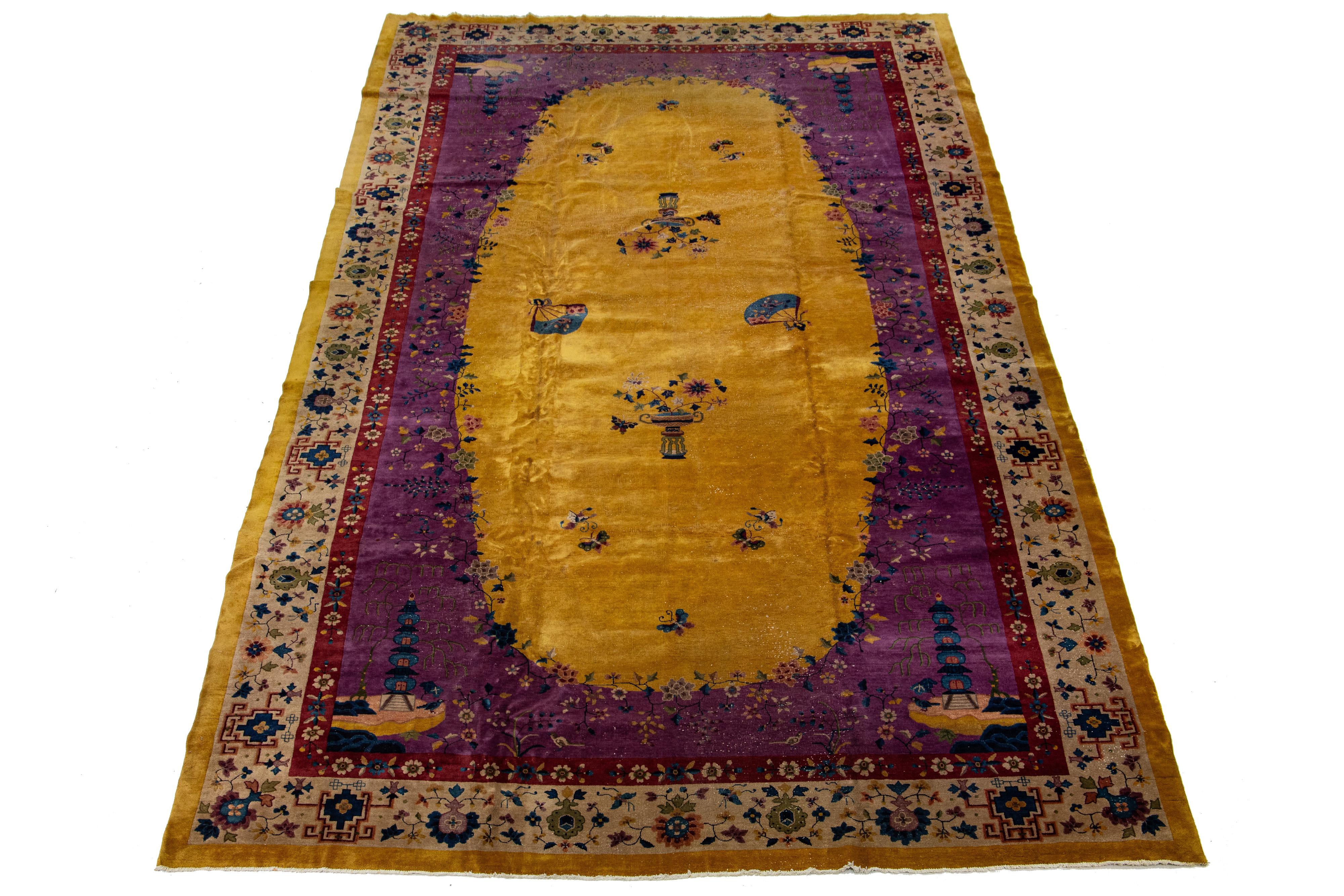 This hand-knotted wool rug showcases Art Deco style and features a goldenrod field complemented by a designed frame. The traditional Chinese floral design has stunning multi-colored accents.

This rug measures 12' x 21'3