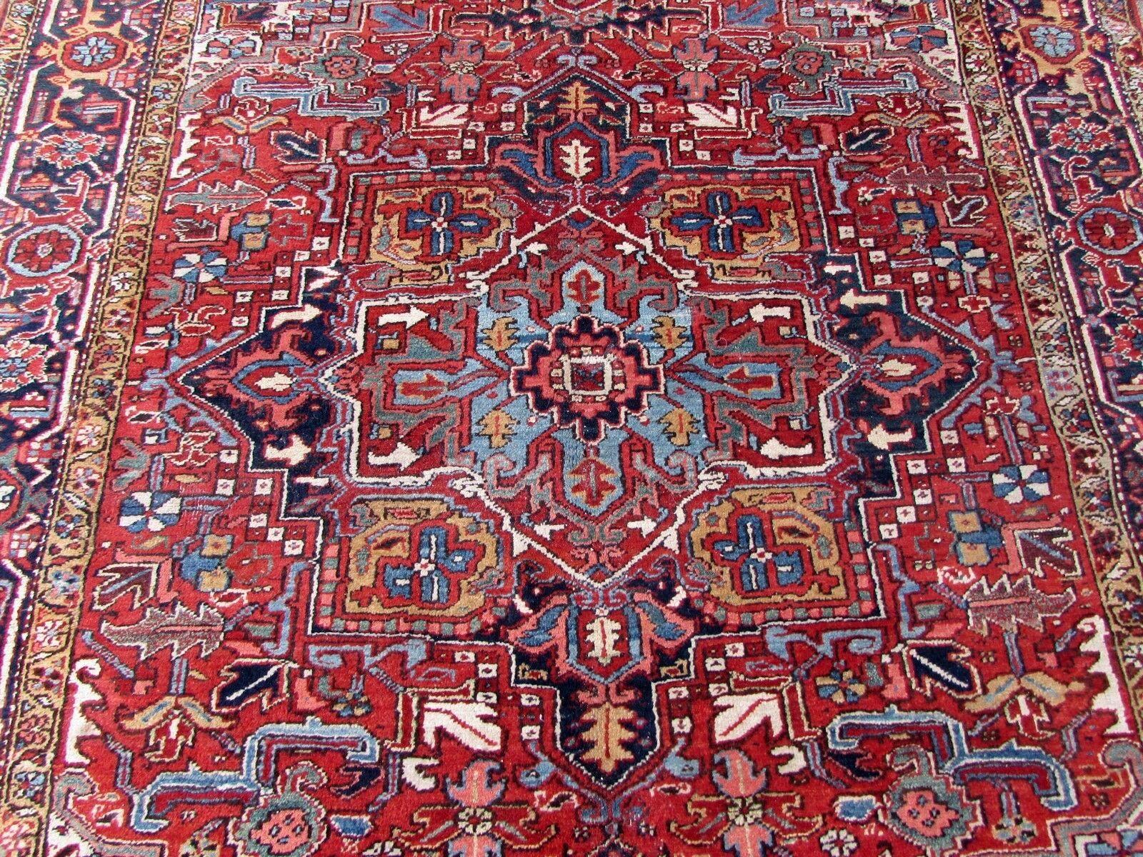 Handmade antique Heriz rug in red wool. The rug is from the beginning of 20th century, it is in original condition, has some low pile.

-condition: original, some low pile,

-circa 1920s,

-size: 6.3' x 8.8' (192cm x 270cm),

-material: