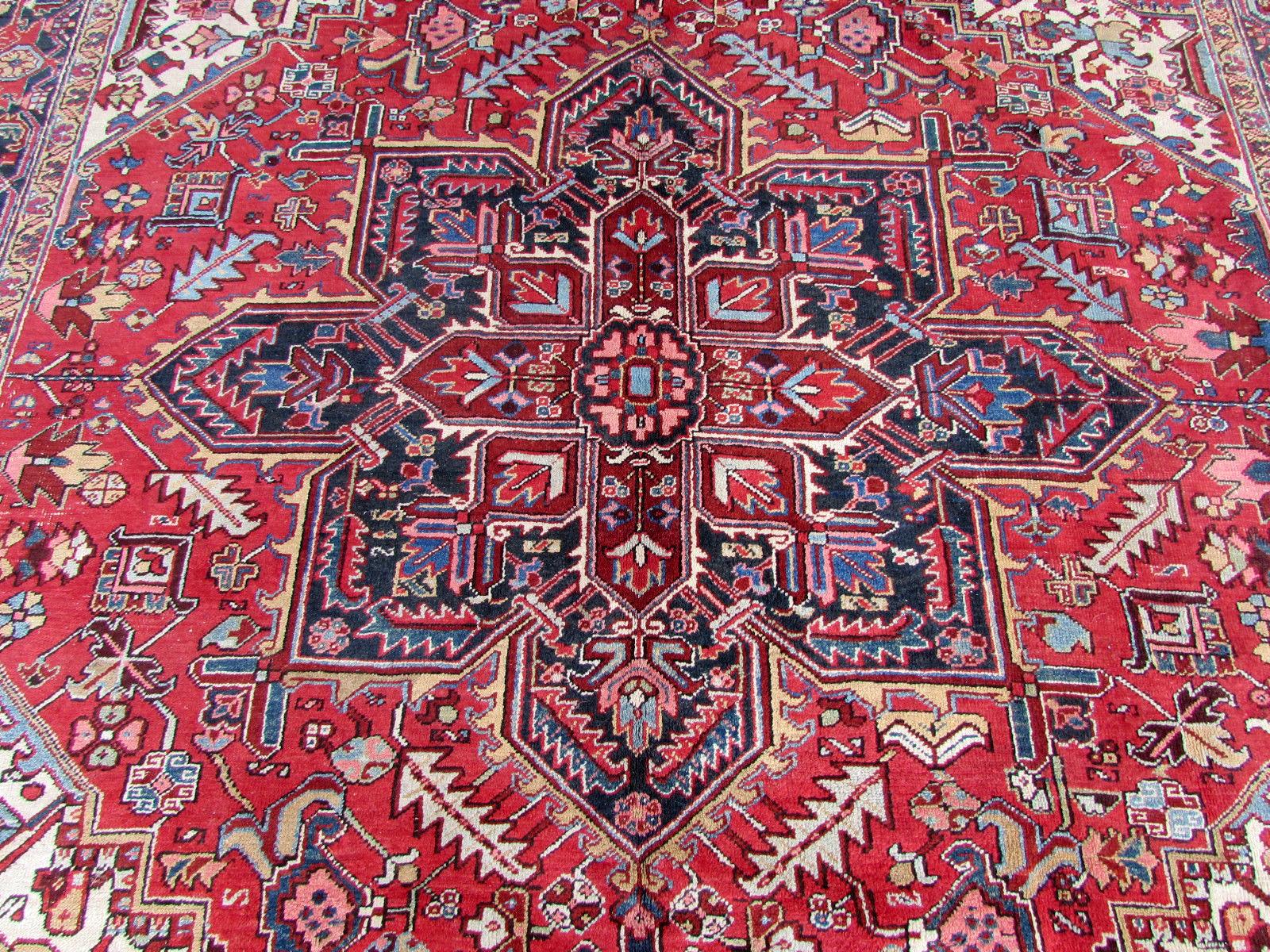 Handmade antique Heriz rug in red wool. The rug is from the beginning of 20th century, it is in original condition, has some low pile.

- Condition: original, some low pile,

- circa 1930s,

- Size: 8.5' x 11.2' (253cm x 335cm),

- Material:
