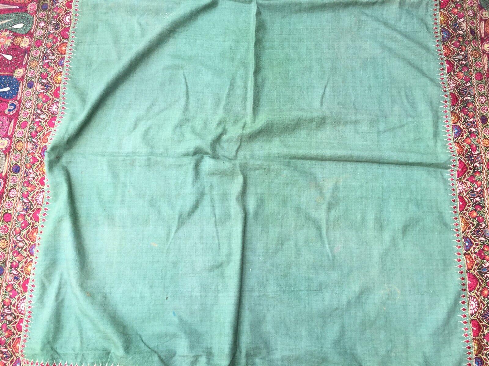Handmade Antique Indian Kashmir Shawl:

Design and Colors:
This square-shaped shawl is a testament to Indian Kashmiri craftsmanship.
The dominant color is a rich green, creating a serene and earthy canvas.
The intricate border design steals the