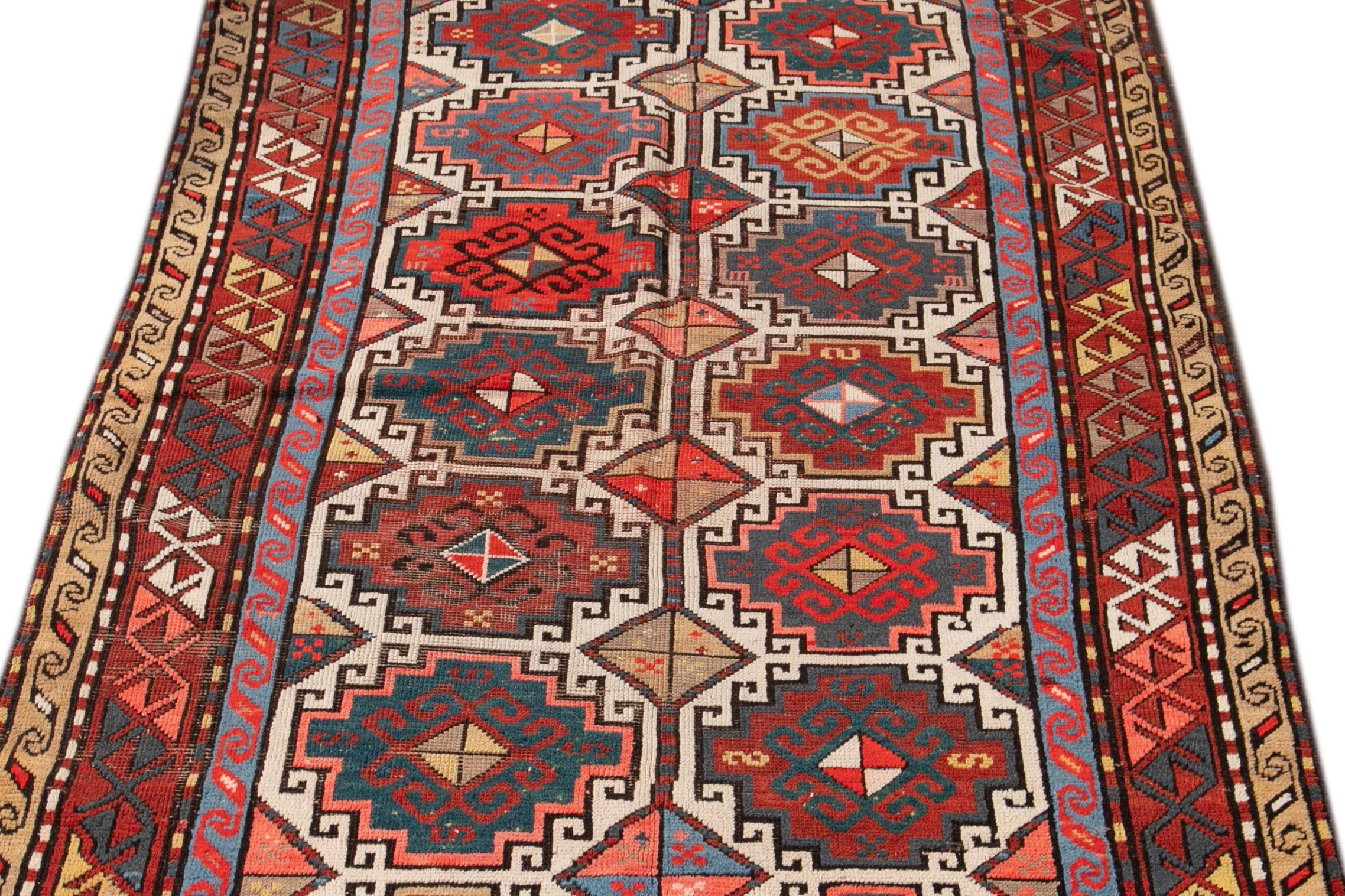 Magnifique tapis ancien de la Galerie Kazak, noué à la main en laine avec un champ multicolore et un motif géométrique.

Ce tapis mesure 4'2