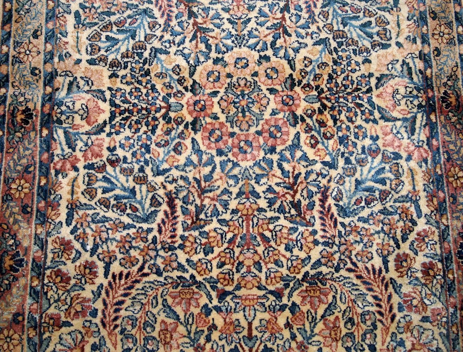 Hand made antique Kerman rug in original good condition from the beginning of 20th century. The rug in in beige shade and with classic floral design.

- Condition: original good,

- circa 1920s,

- Size: 3.1' x 5.2' (94cm x 158cm),

-