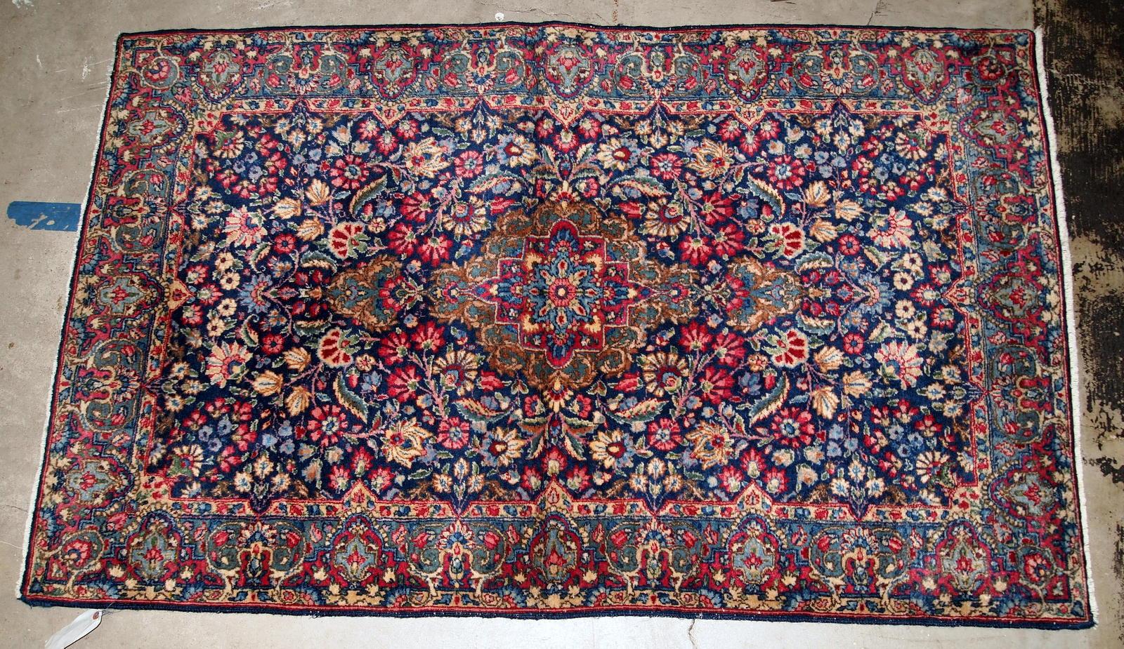 Handmade antique Kerman rug from the beginning of 20th century. The rug is in original good condition made in colorful shades and floral design.

-condition: original good,

-circa 1920s,

-size: 4' x 6.4' (122cm x 195cm),

-material: