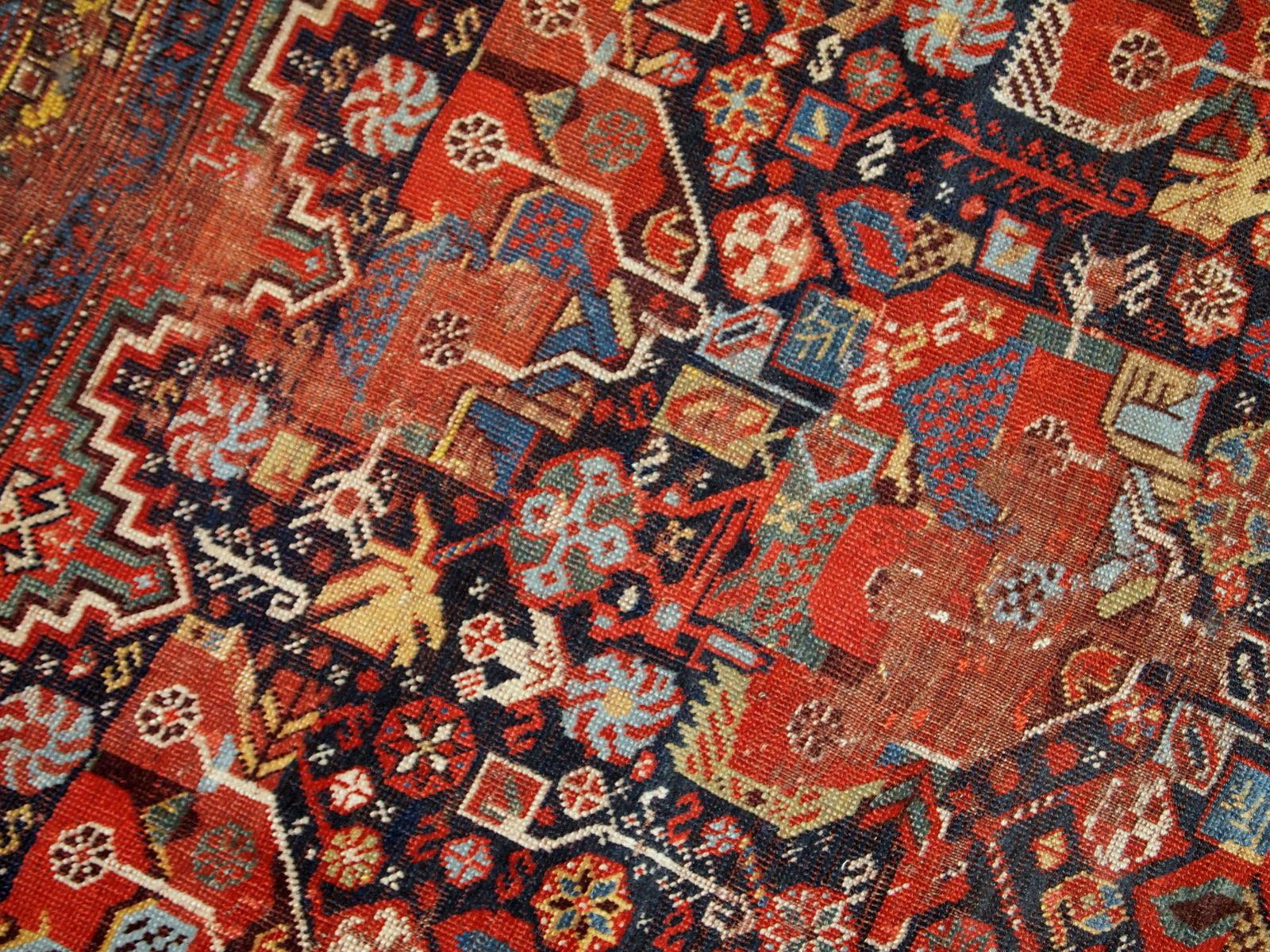 Antique handmade collectible Khamseh rug from the mid-18th century. It is in bright natural colors and in distressed condition.

Condition: Original, distressed,

circa 1840s,

Size: 4.9' x 6.4' (149cm x 195cm),

Material: Wool,

Country