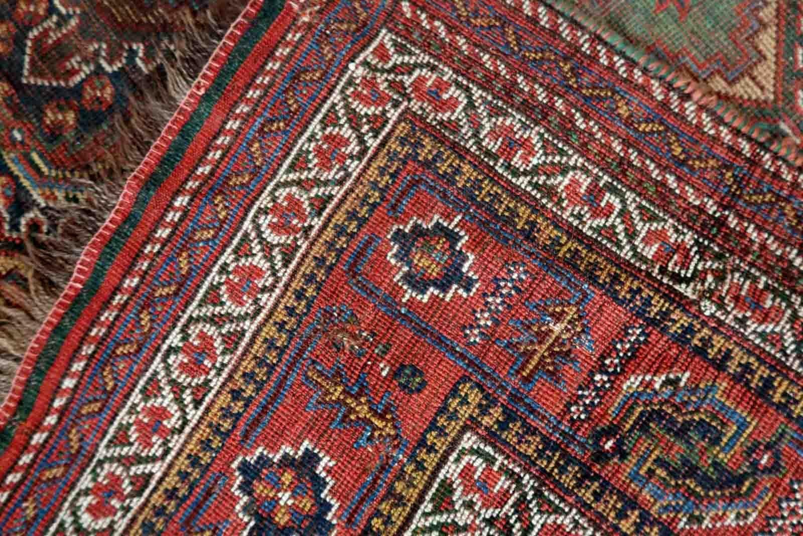 Handmade antique oversized Khamseh rug in traditional design. The rug is from the end of 19th century in distressed condition.