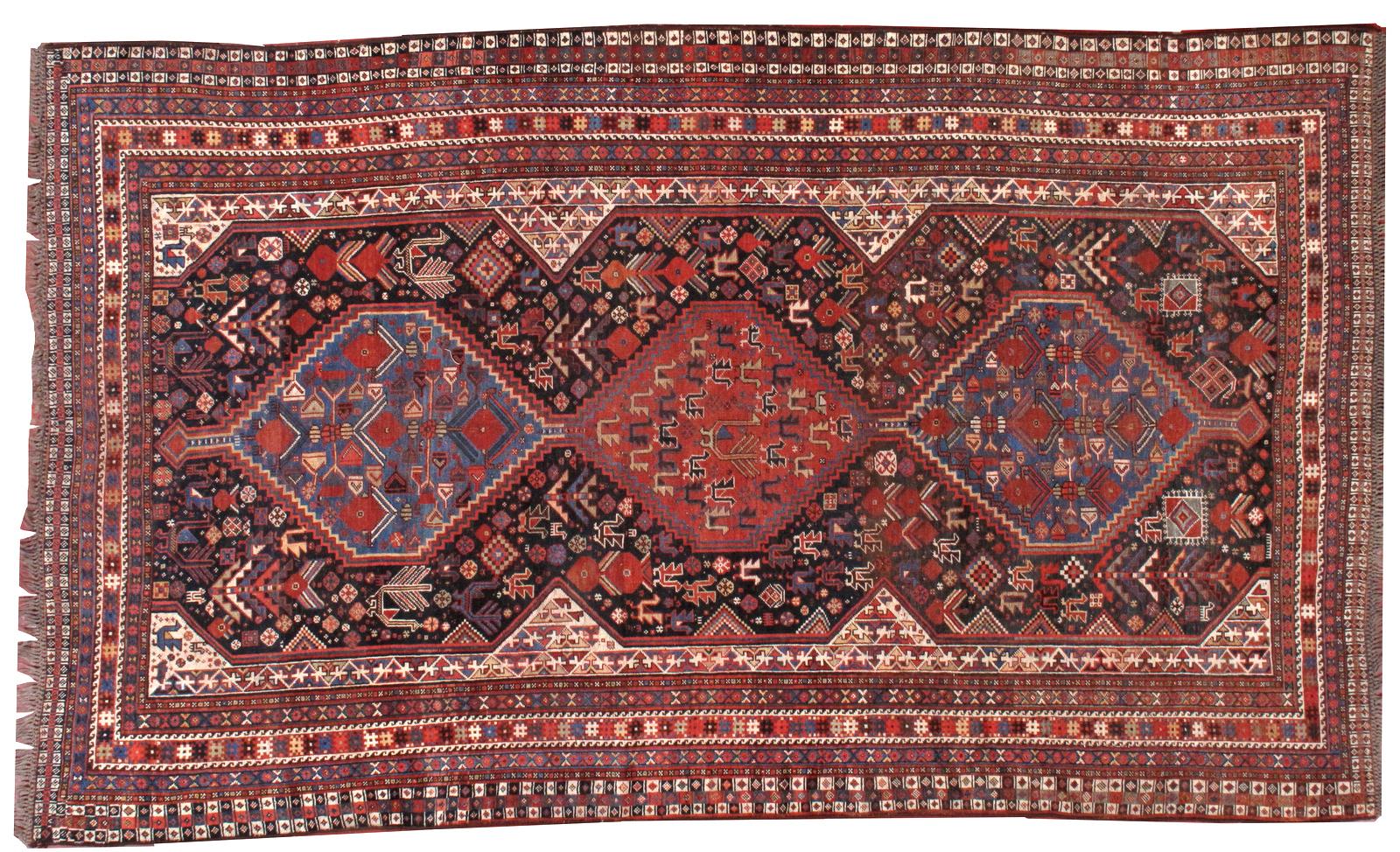 Khamseh carpet, late 19th century, three medium blue and red contiguous stepped hexagons on a navy blue/red field displaying polychrome stylized birds, 