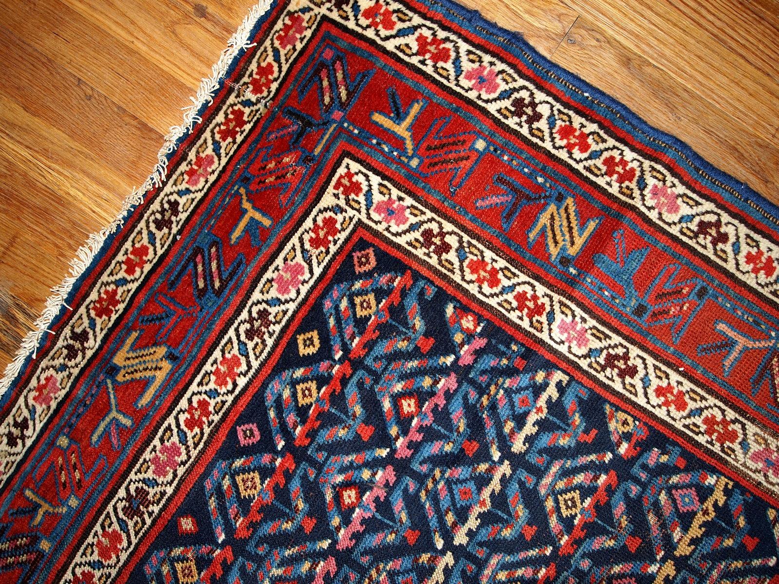 Antique hand made Kurdish style distressed runner 3.4'x12.3' (103cmx375cm) in dark blue shade. The rug has some age damages and a patch.