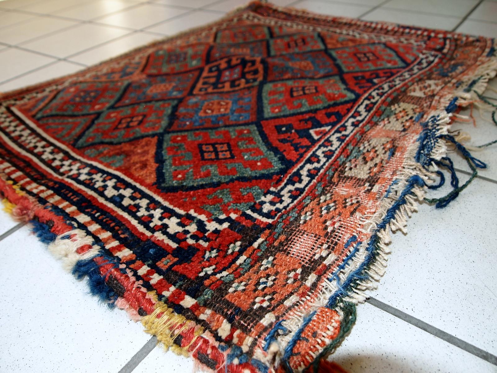 Handmade antique collectible Persian Kurdish bag in original condition, it has some age wear. This bag has typical Jaff design with repeating diamond in different shades. The back side Kilim is striped in red and chocolate brown shades.
