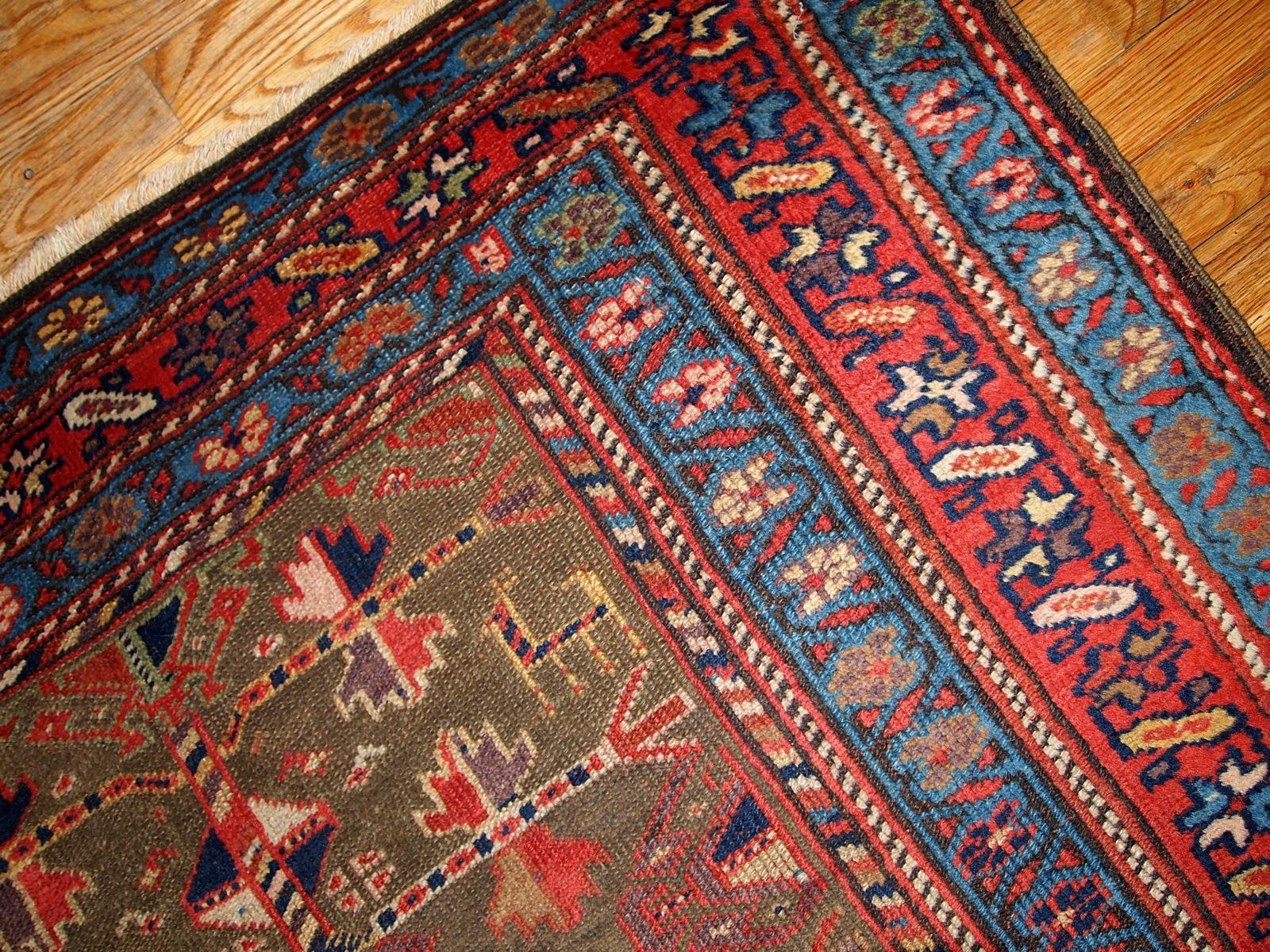 Antique Kurdish style rug in swampy green, red and blue colors. This rug is from the end of 19th century in good condition. Measures: 4' x 7.6' (122cm x 231cm).