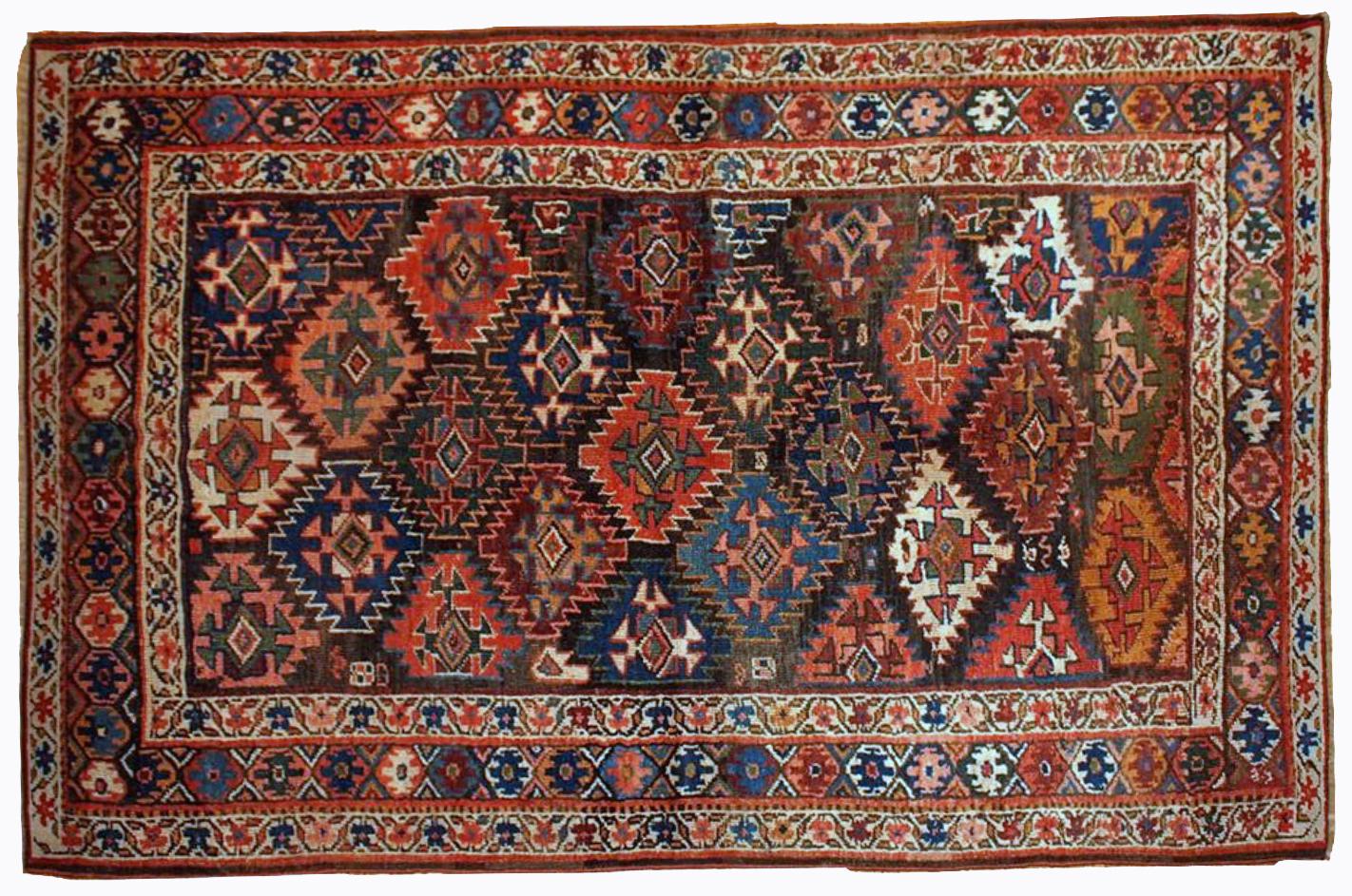 Antique Kurdish style rug in chocolate brown background color and repeating pattern. This rug has Jaff Kurdish design. It is in original good condition. Measures: 4.2' x 6.3' (128cm x 193cm).
 