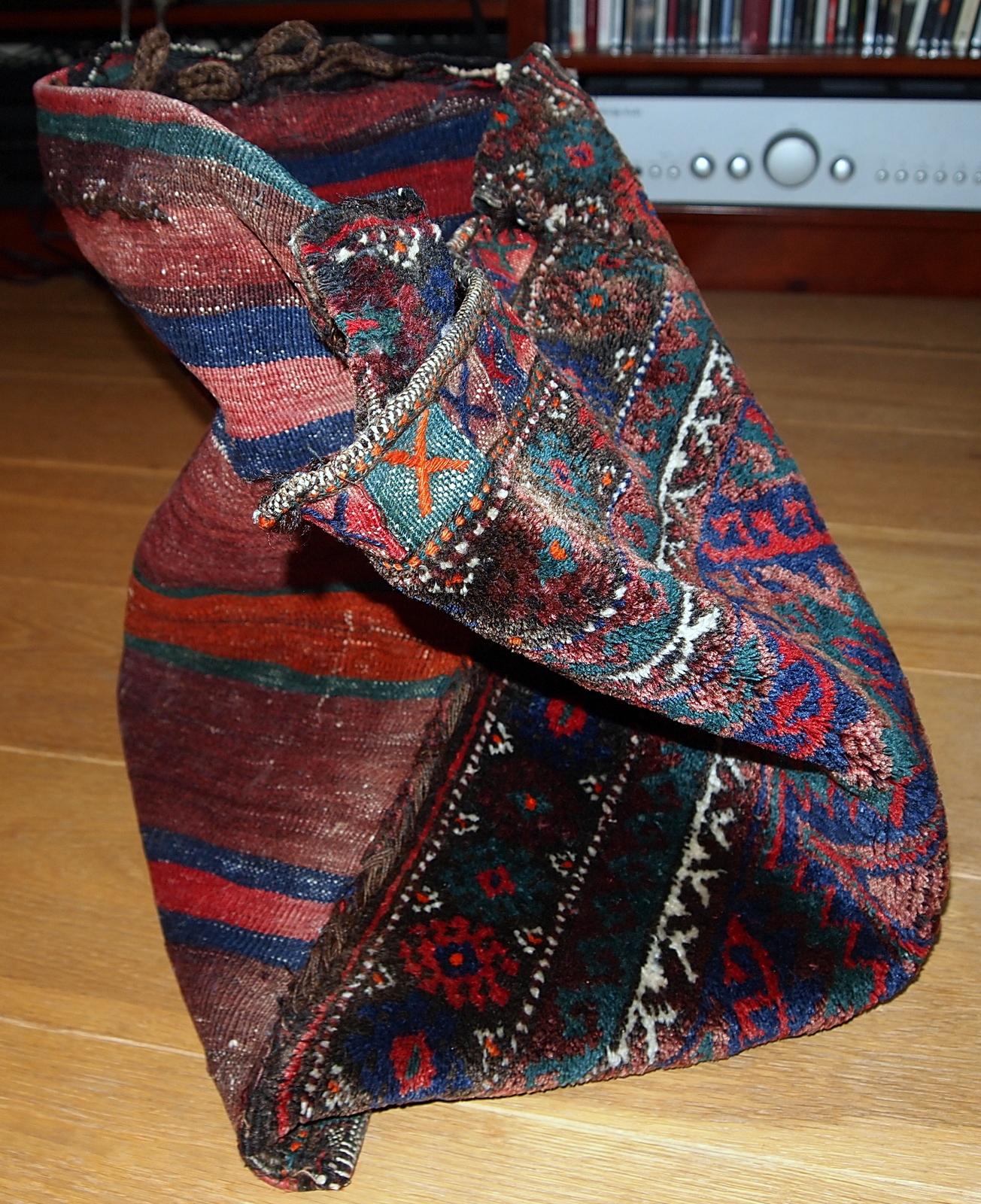 Antique Kurdish salt bag in original good condition. The colours of this bag are very different, from very bright to a darker shades. The back side of this bag made out of striped kilim in orange, green, blue and brown shades. Measures: 1.6' x 1.9'