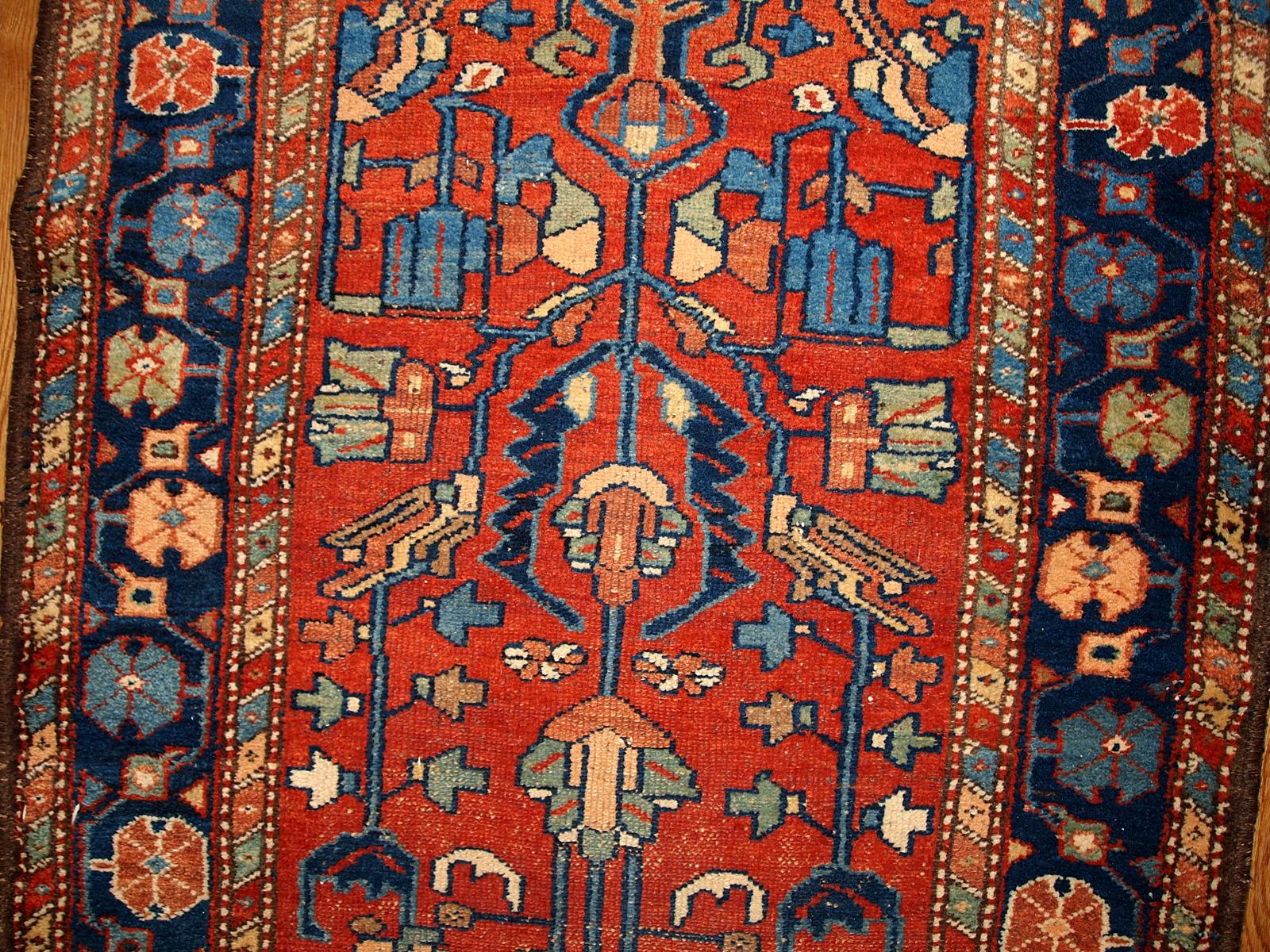 Antique Lilihan style rug in red and blue colours. This runner is from the beginning of 20th century in original good condition. Measures: 3.3' x 10.2' (100cm x 310cm).