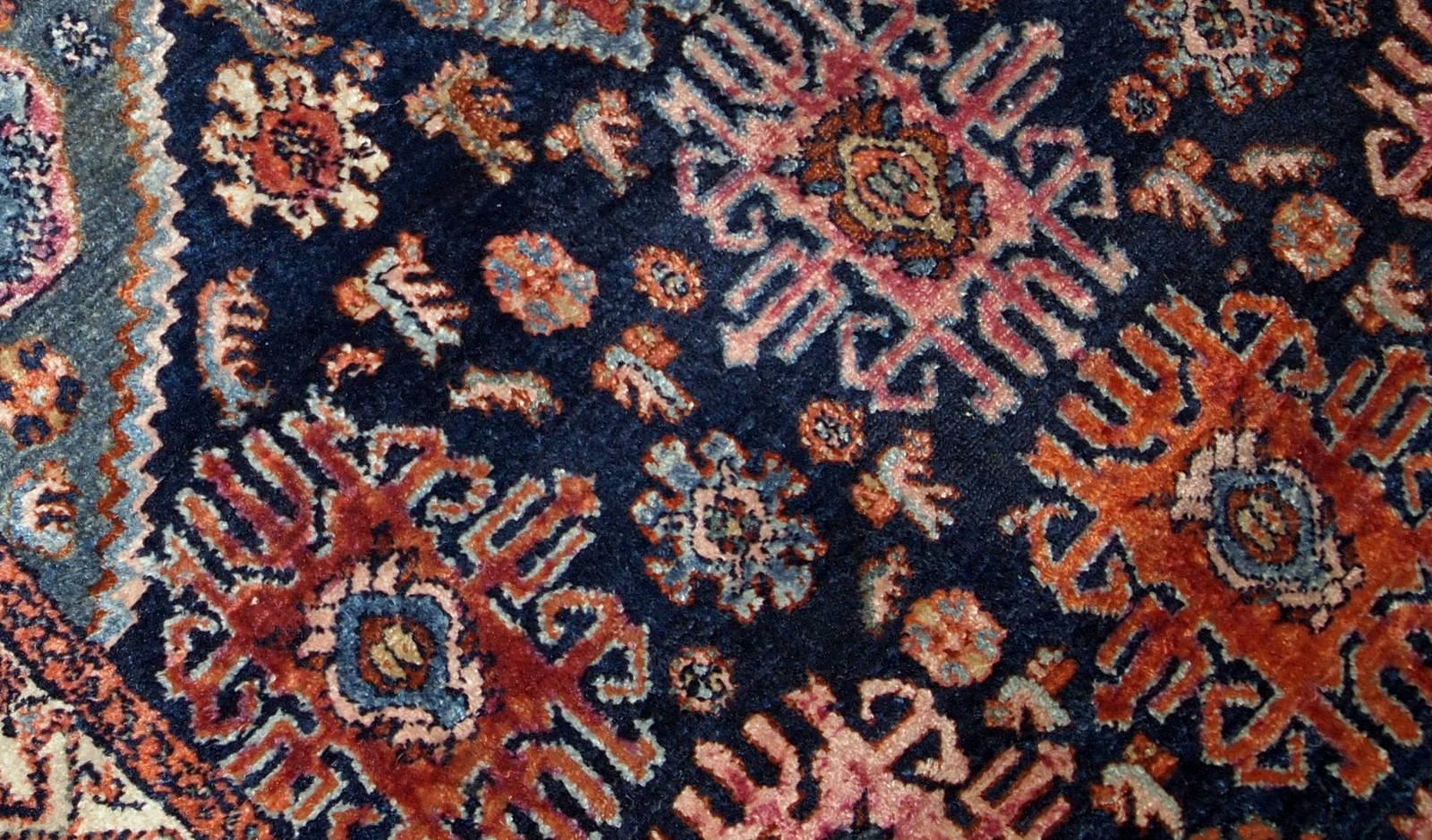Handmade antique Malayer rug from the beginning of 20th century. The rug is in original good condition, has all-over design on navy blue background.

-condition: original good,

-circa: 1910s,

-size: 4.1' x 6.3' (125cm x 192cm),

-material: