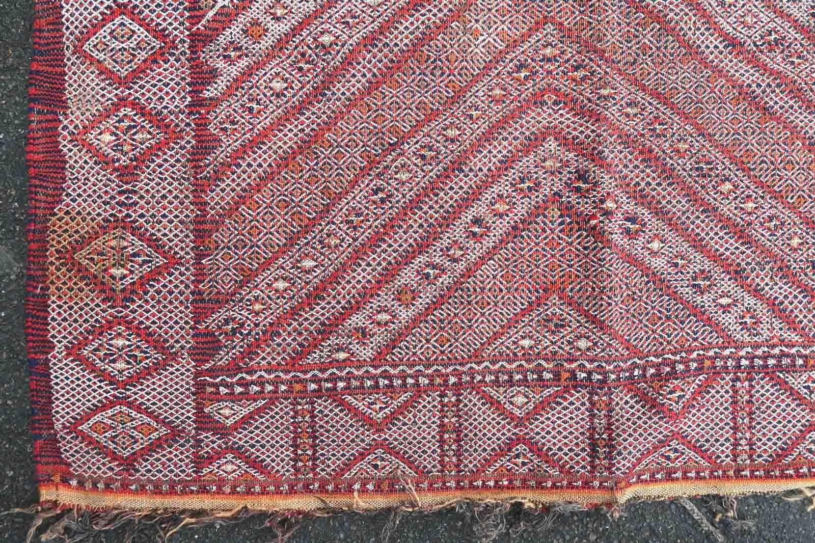 Handmade antique Moroccan Berber kilim in geometric design from Atlas region. The rug is from the end of 19th century generally in good condition, it has some age wear and old restorations. This type of rugs has been made for a personal use and not