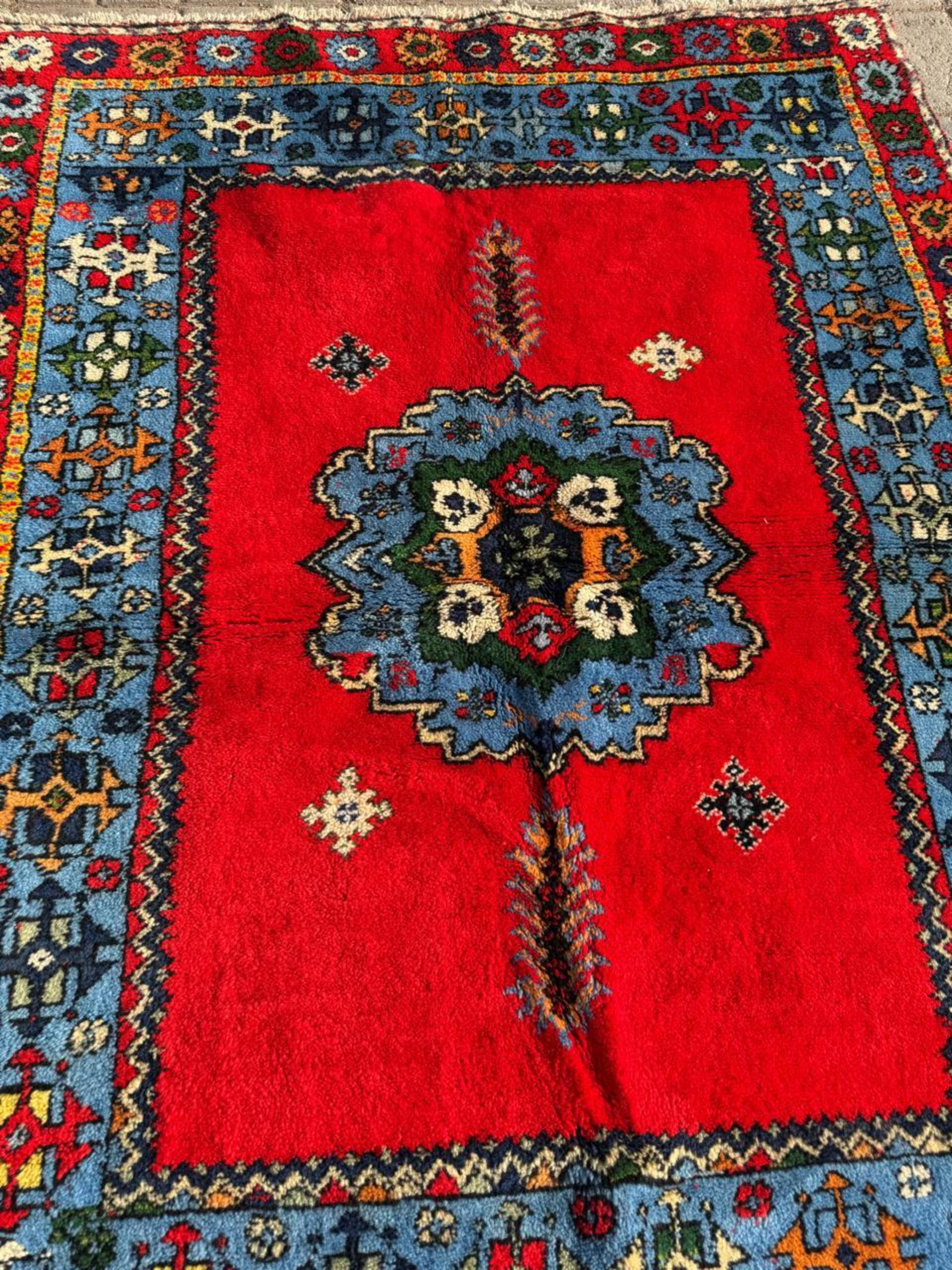 Command attention in your space with this incredibly vibrant Handmade Antique Moroccan Berber Rug. A true piece of North African textile history, this rug was hand-knotted around the 1920s and originates from the Berber tribes of the Atlas