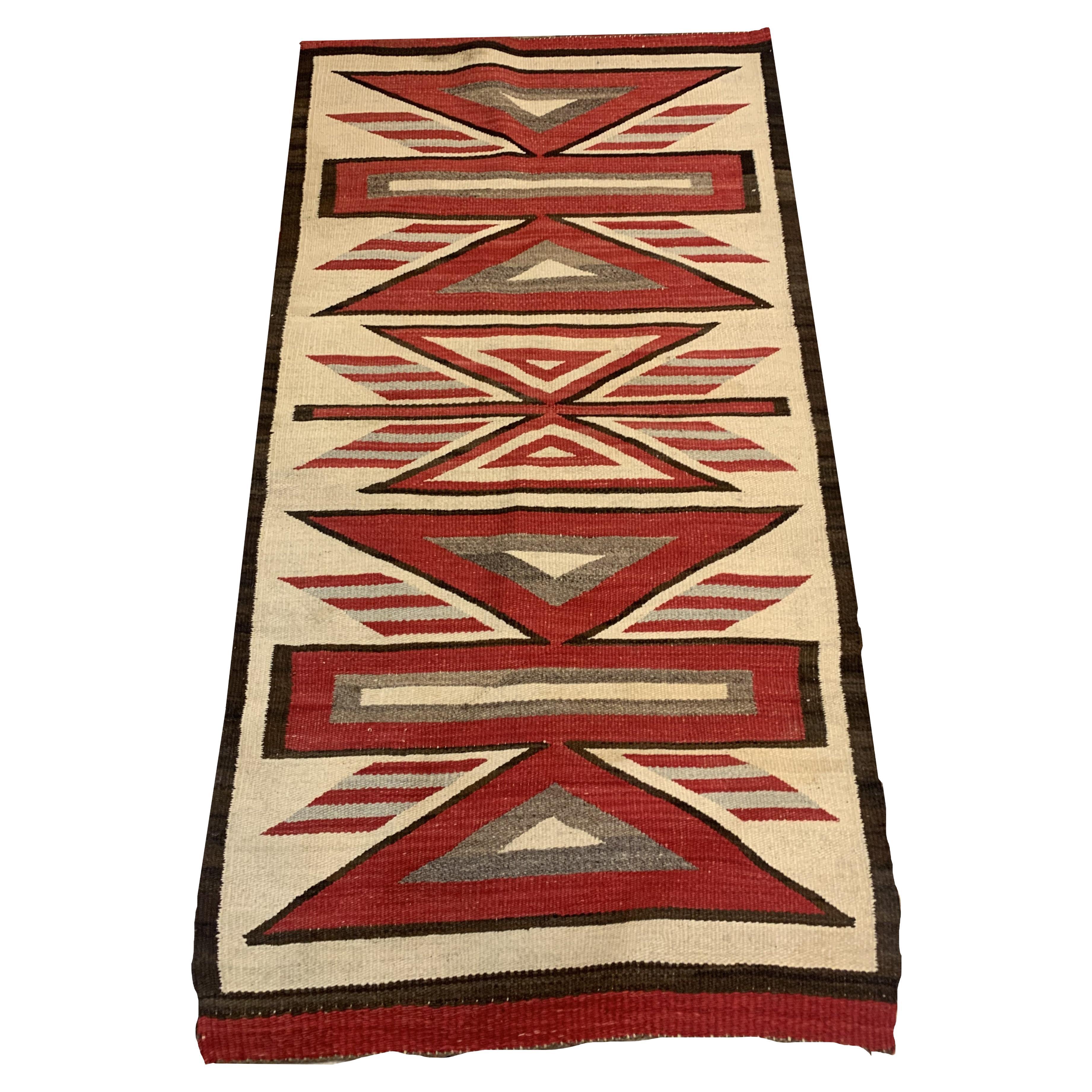 Introducing our Handmade Antique Native American Navajo Rug, a captivating piece steeped in history. Measuring 2.10’ x 5.2’ (89cm x 158cm), this rug from the early 1900s is in good condition, crafted from wool.

Colors & Design: The rug showcases a