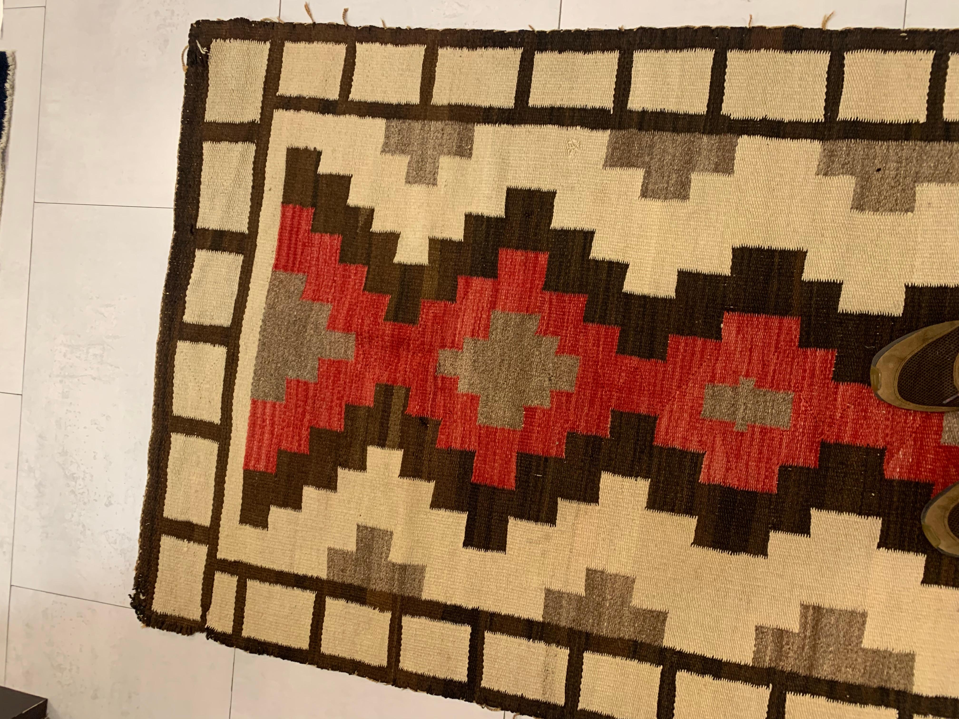Introducing our Handmade Antique Native American Navajo Rug, a unique piece that brings history and artistry into your space. Measuring 3.3’ x 6’ (100cm x 182cm), this rug from the early 1900s is in good condition, showcasing the impeccable