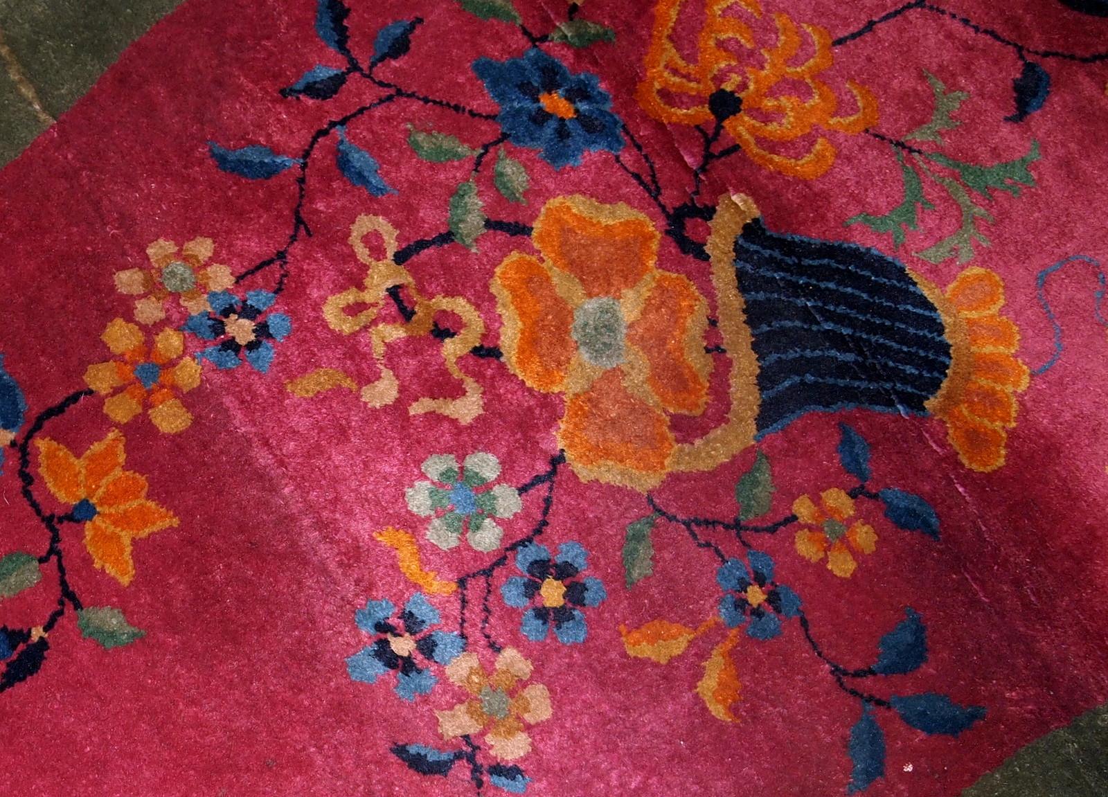 Handmade antique oval decorative rug from China in original good condition. The rug is in fuchsia and green shades.

- Condition: original good,

- circa: 1920s,

- Size: 2.10' x 4.10' ( 89cm x 150cm ),

- Material: wool,

- Country of