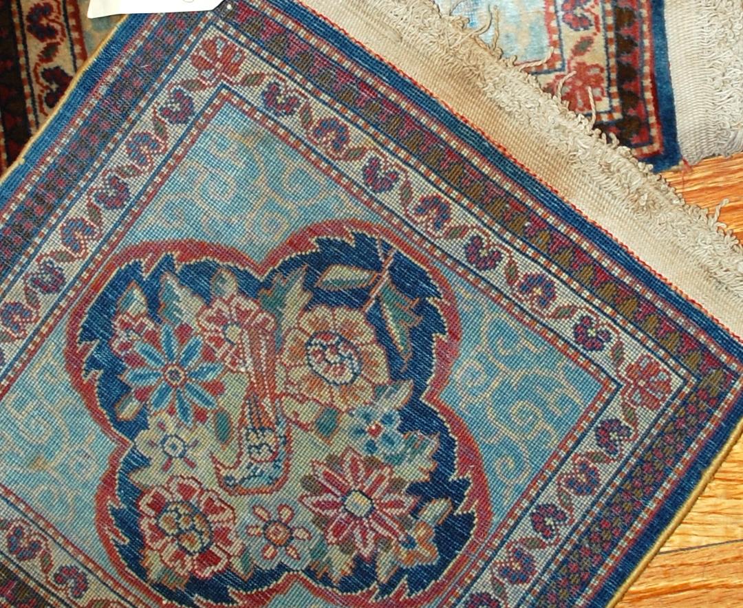 Handmade pair of antique collectible Dabir Kashan style rugs in original good condition. The rugs has classy Dabir Kashan design with medallion in the shape of four petals flower and the bird in it surrounded by flowers. Measures: 1.7' x 2.1' (52 cm