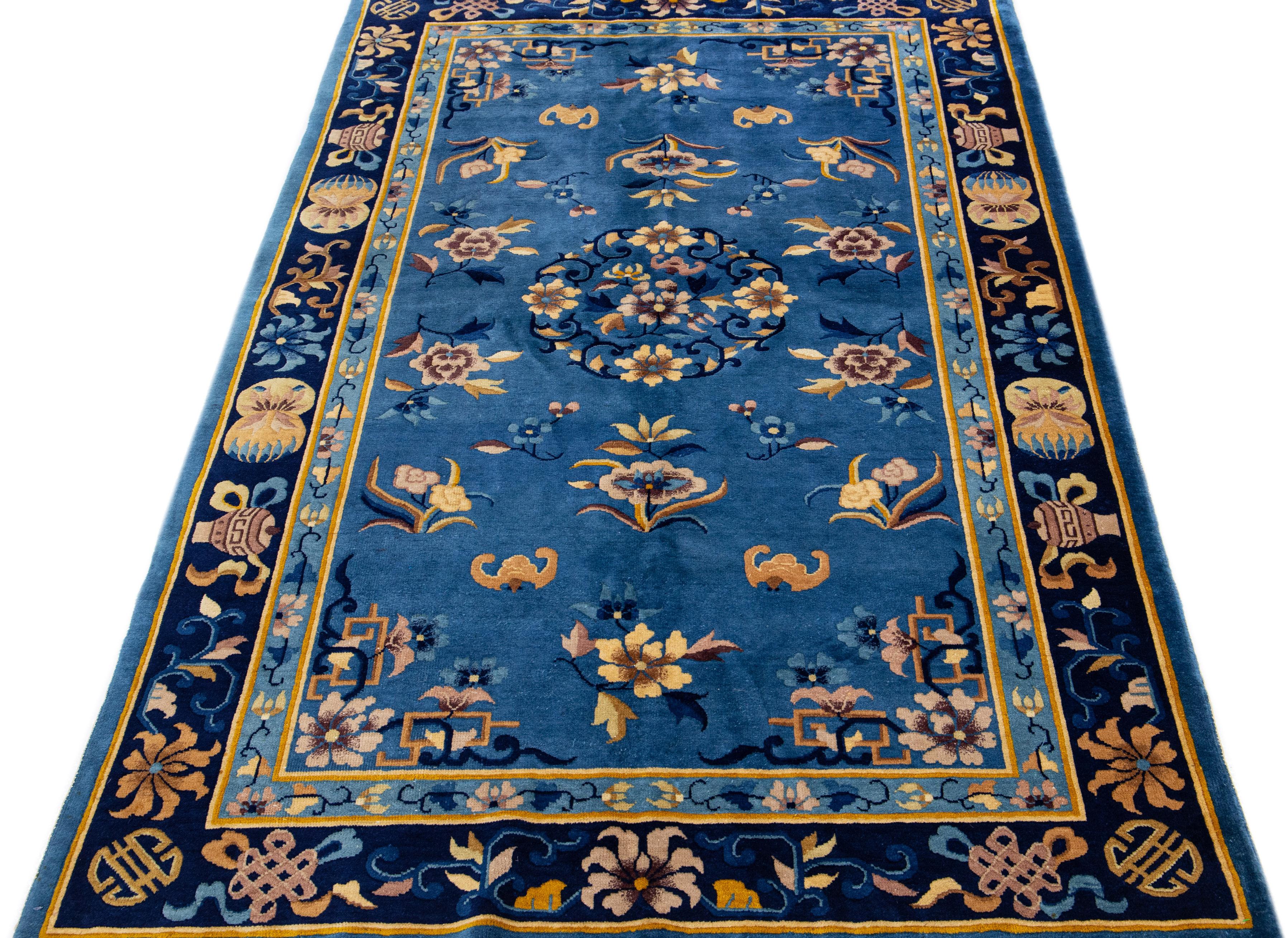 Upgrade your interior decor with this superior-quality handmade Chinese rug. Our beautiful traditional Chinese rug has a stunning blue field, multicolor accents, and a classic allover Peking pattern. This enchanting antique wool rug will make a