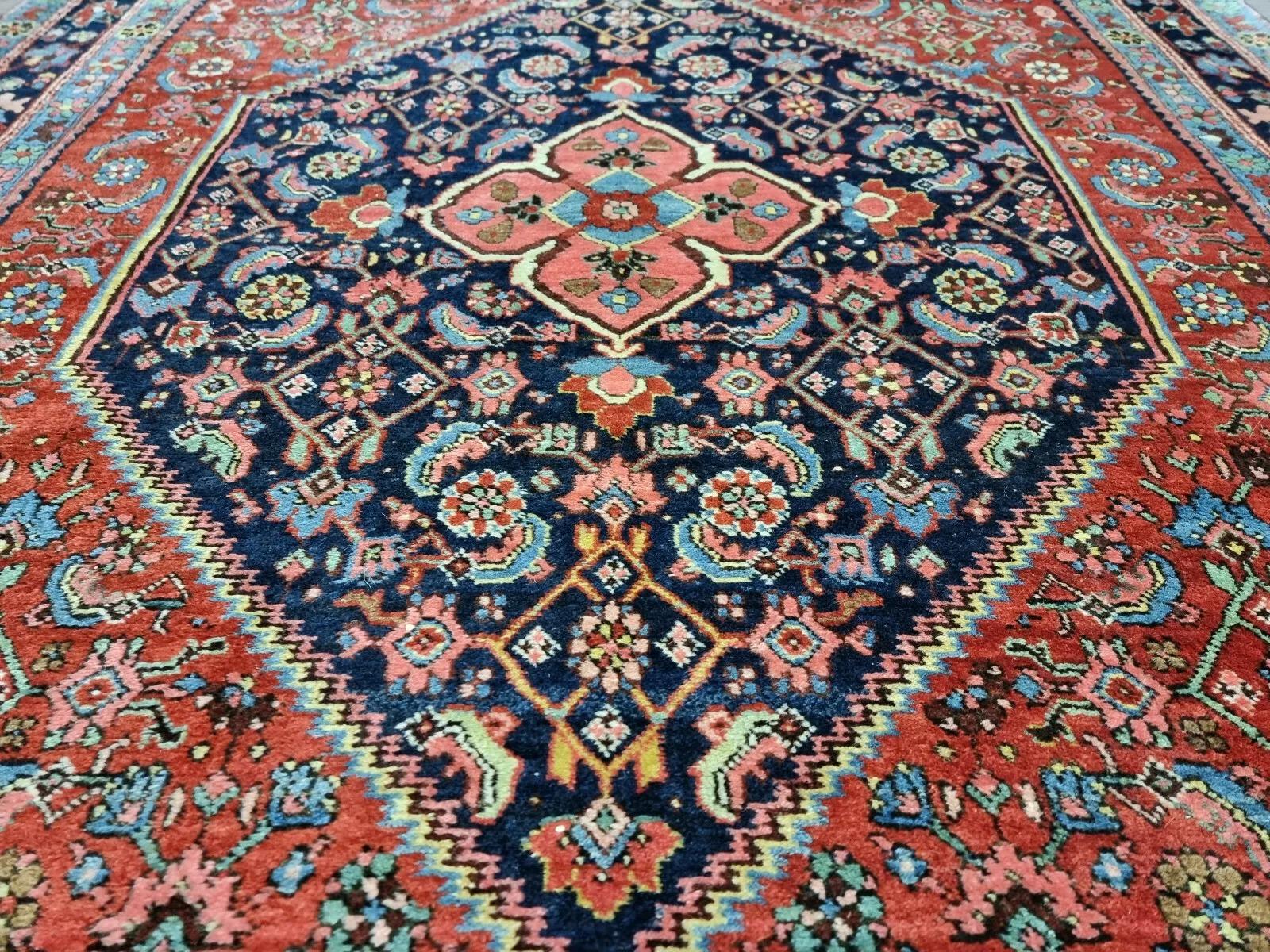 This exceptional antique Persian Bidjar rug, hand-knotted circa 1910s, embodies the durability and beauty for which Bidjar rugs are renowned. Featuring a geometric pattern in rust-red hues, it is a stunning piece with over a century of history,