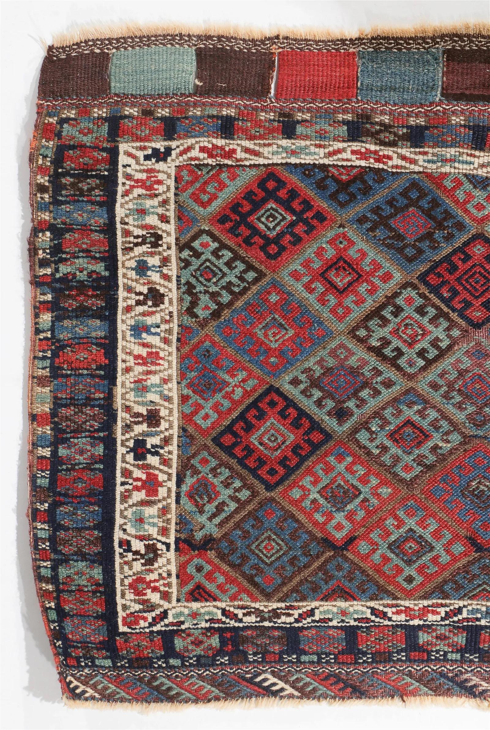 Transport yourself to the cultural heart of Persia with this Antique Jaff Kurd Bag Face, originating from the renowned weaving traditions of Persia. Dating back to circa 1875, this captivating rug measures 3 feet 3 inches in width and 2 feet 9