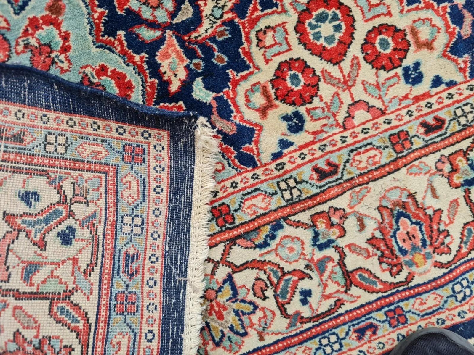 A Timeless Masterpiece from Persia
This exquisite antique Persian Kashan rug, dating from the 1920s, is a testament to the enduring artistry of traditional weaving. Handmade with meticulous attention to detail, this wool rug embodies classic