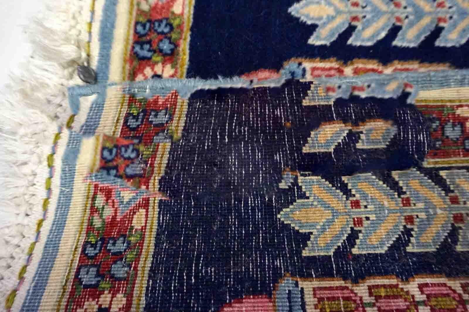 Introducing a stunning Handmade Antique Persian Kerman Mat from the 1930s. This authentic rug is made from premium quality wool and boasts a beautiful design featuring navy blue, sky blue, pink, and red colors in a Kerman style. The rug measures