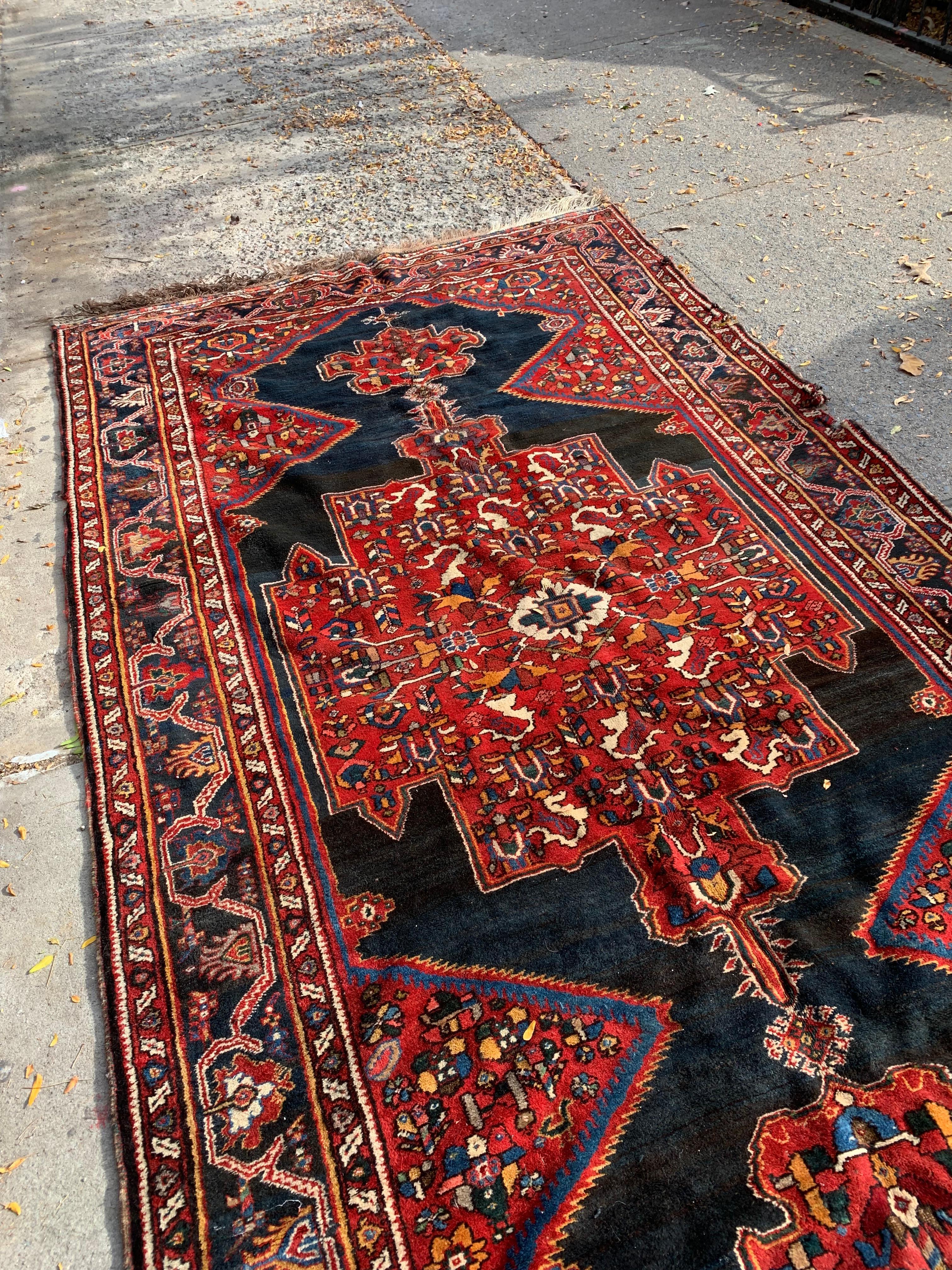 Immerse your home in the rich artistry of Persian craftsmanship with this handmade antique Persian Luri wool rug, dating back to the 1880s. This extraordinary piece showcases the vibrant colors and geometric patterns characteristic of traditional
