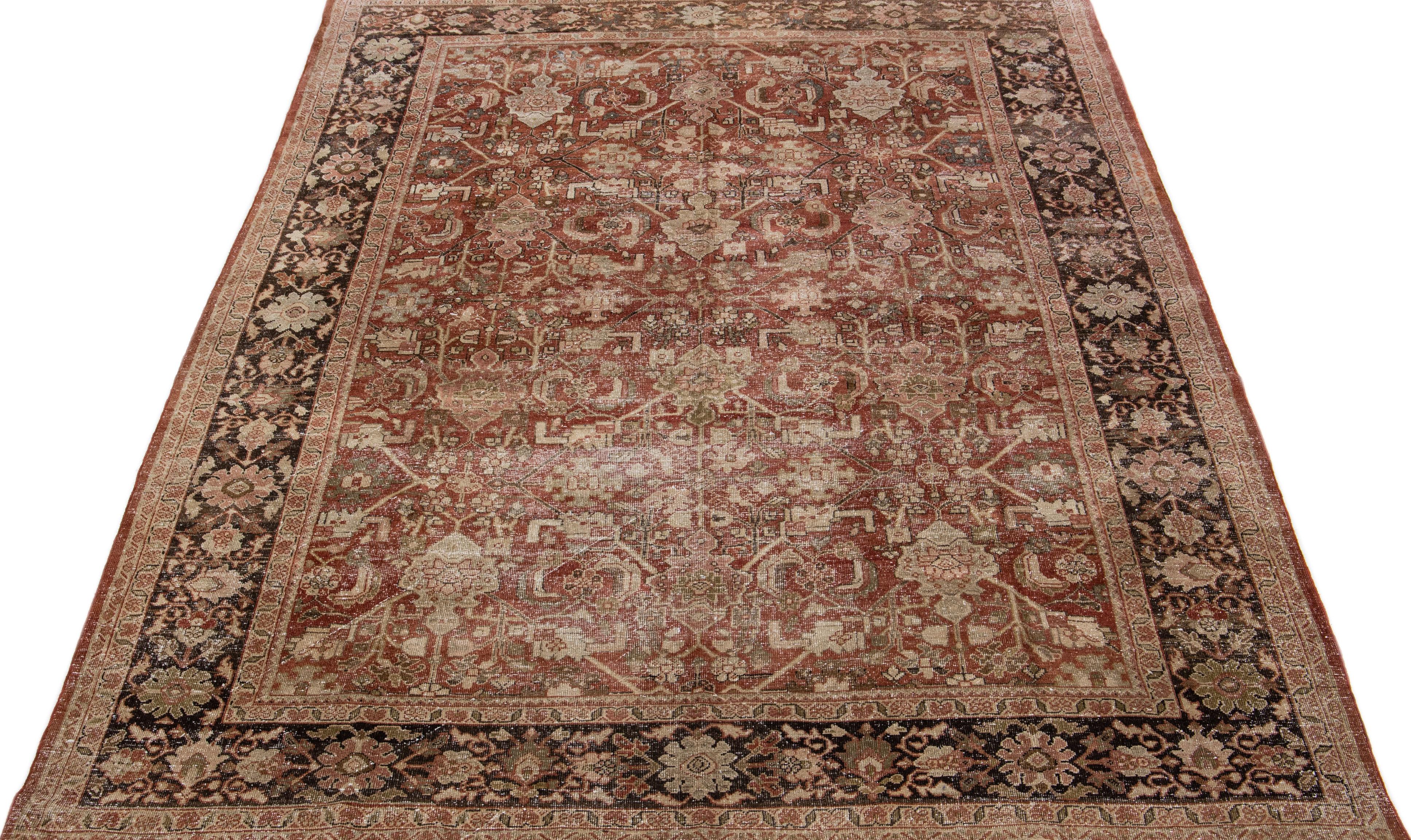 Beautiful hand-knotted antique mahal wool rug with a red-rust color field. This Persian rug has brown and beige accent colors in an all-over floral design. 

This rug measures: 7'6