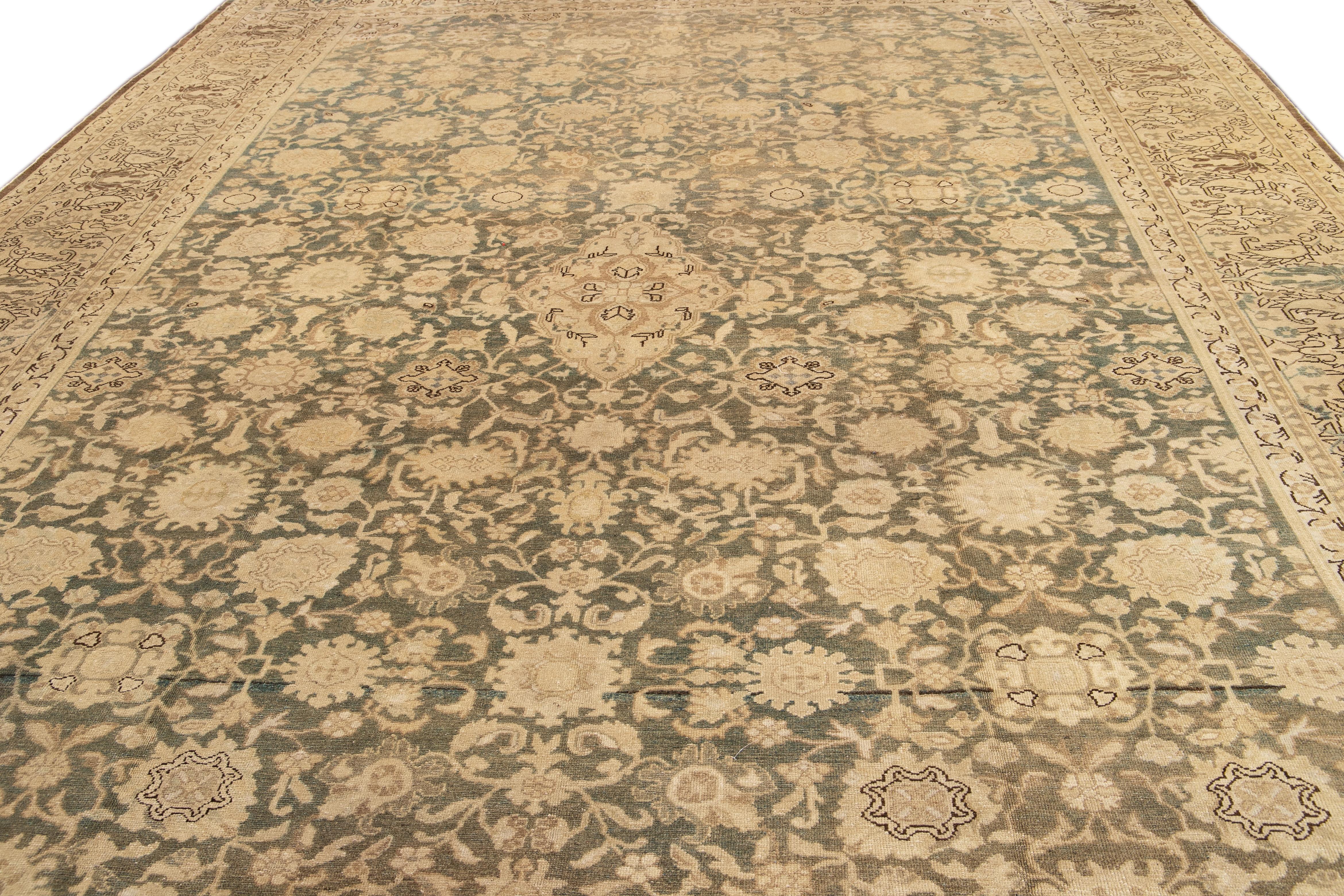This stunning antique Persian Malayer rug is fashioned from meticulously hand-knotted wool, featuring a serene gray field adorned with ivory and tan accents in an exquisite all-over classic design.

This rug measures 12' 4