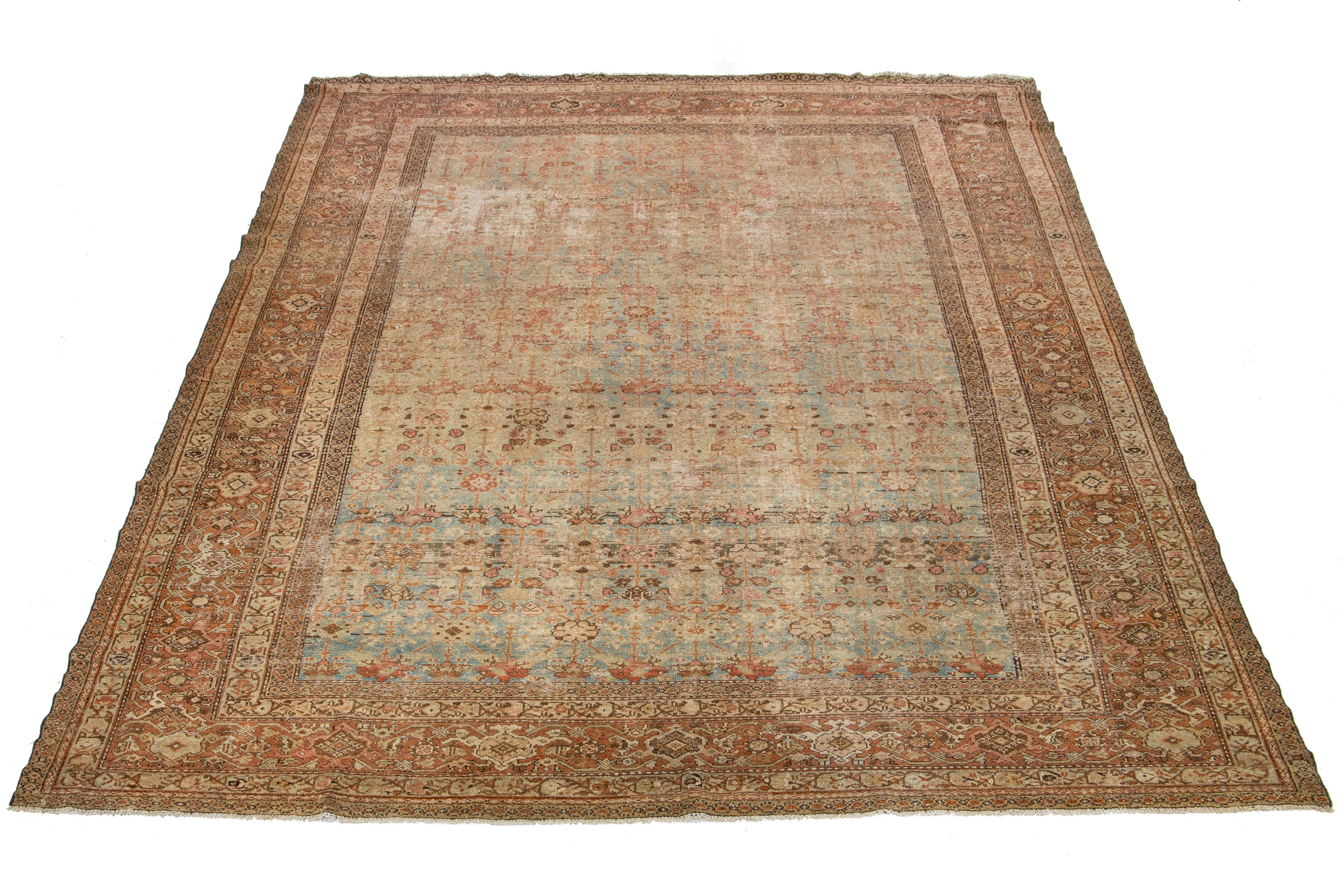 Beautiful room-size antique Malayer hand-knotted wool rug with a blue color field. This Persian rug has a gorgeous all-over floral design with terracotta and brown accents.

This rug measures 10'3