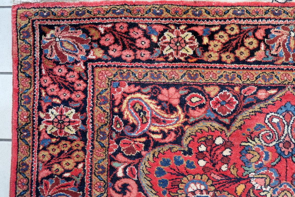 This handmade antique Persian Mashhad rug from the 1930s is a gorgeous, finely crafted wool carpet featuring intricate floral patterns and rich traditional colors. A perfect statement piece for collectors and interior decorators alike!

Key