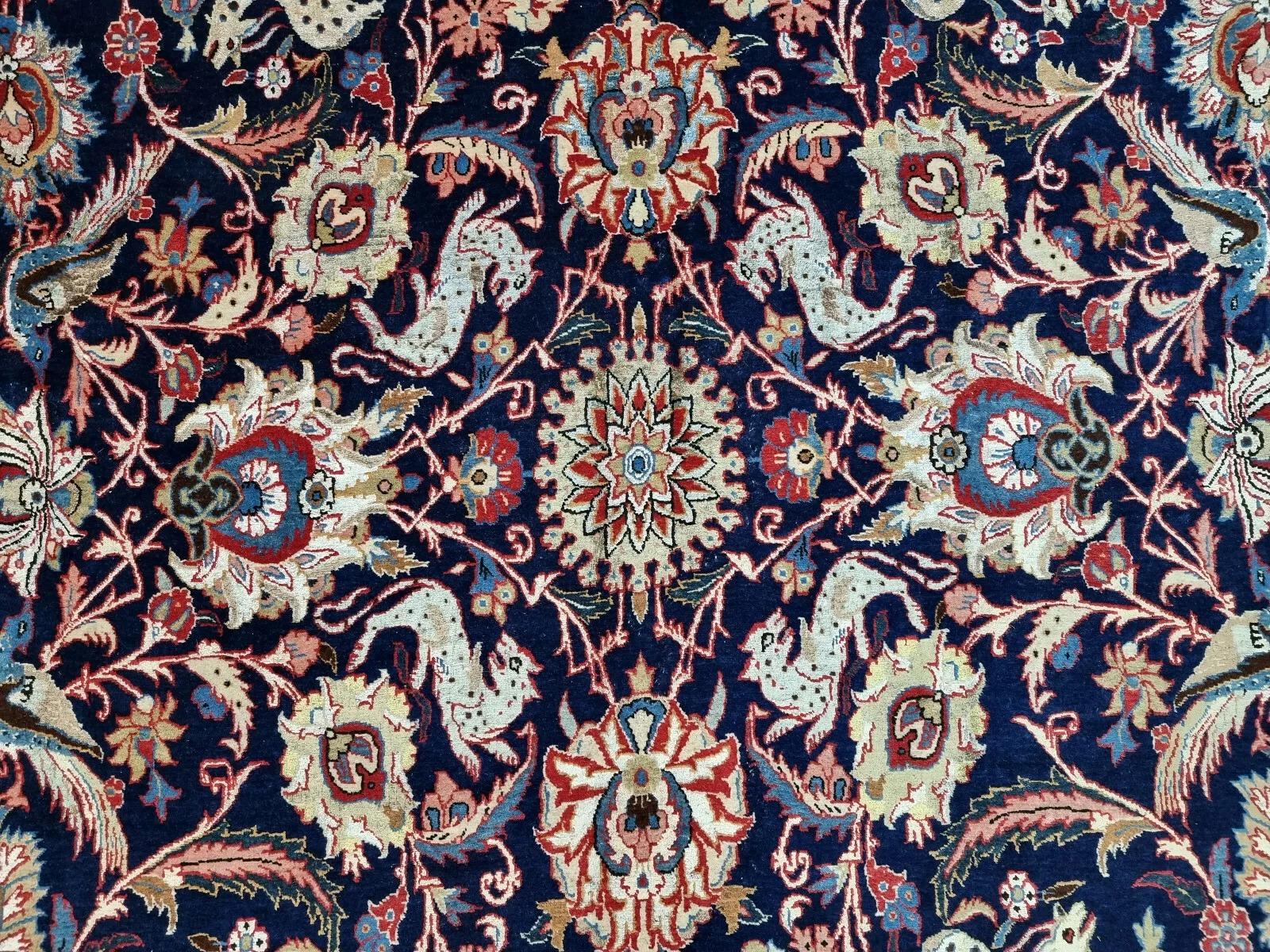 This stunning original Qum rug is a timeless masterpiece, hand-knotted with exceptional craftsmanship. Featuring intricate Oriental patterns in shades of blue, this rug is a beautiful blend of high-quality wool and silk on a durable cotton