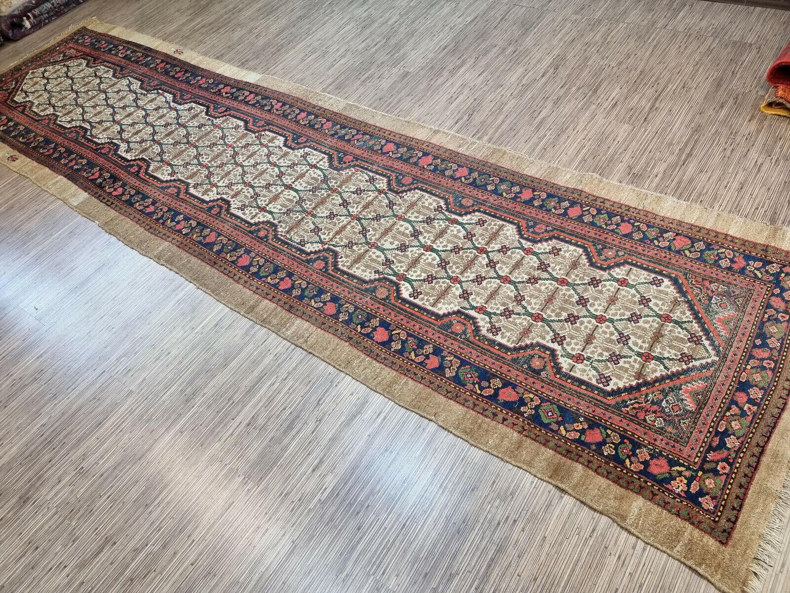 Add a touch of history and artistry to your space with this Handmade Antique Persian Style Camel Hair Runner Rug. This stunning piece measures 4’ x 14.4’ and dates back to the 1900s, making it a rare and valuable find. It is in good condition and