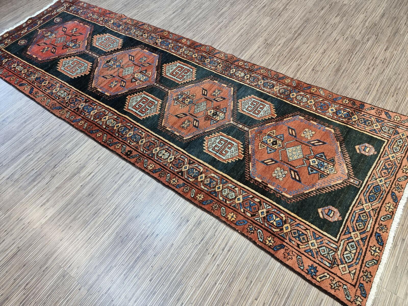 Enhance your home decor with our Handmade Antique Persian Style Hamadan Rug. This gorgeous rug was woven in the 1920s by skilled artisans from the Hamadan region. The rug measures 3.2’ x 9.1’, making it suitable for any room.

The rug is made from