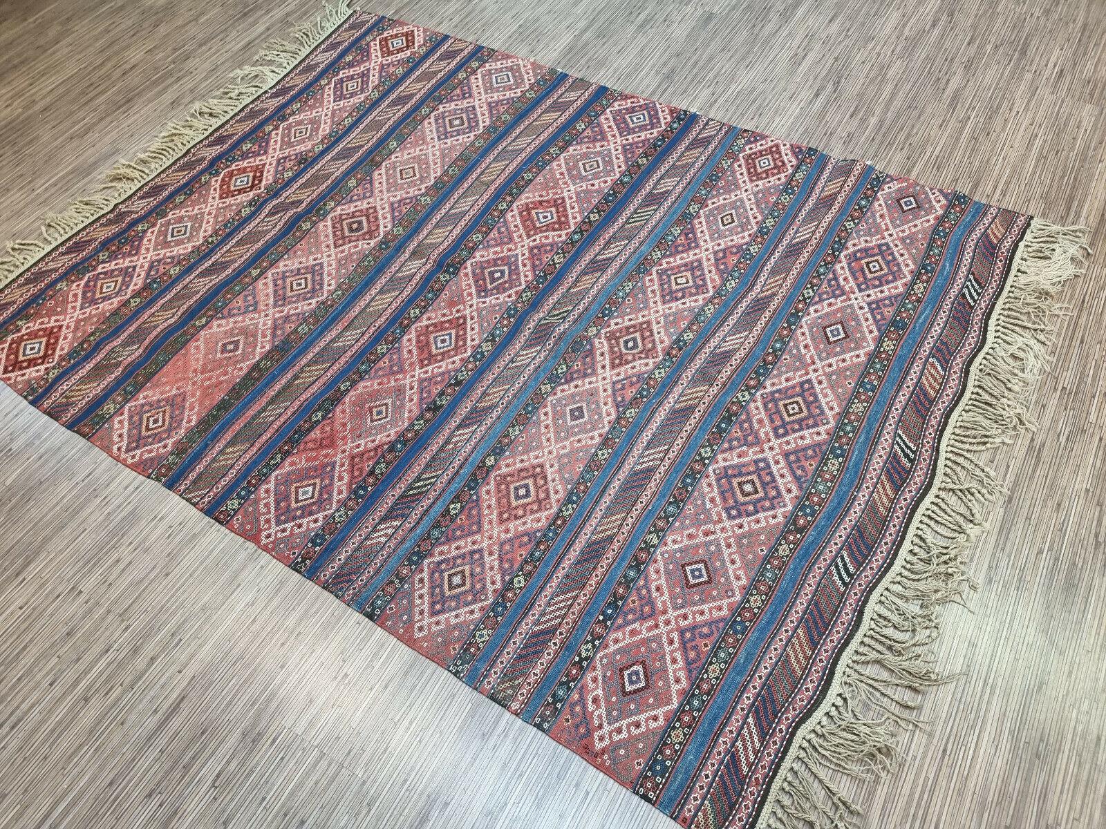 Handmade Antique Persian Style Sumak Kilim Rug 5.4’ x 7’, 1920s, Good Condition, Wool

Add a splash of color and style to your space with this handmade antique Persian style Sumak kilim rug. This beautiful rug was crafted in the 1920s, showcasing