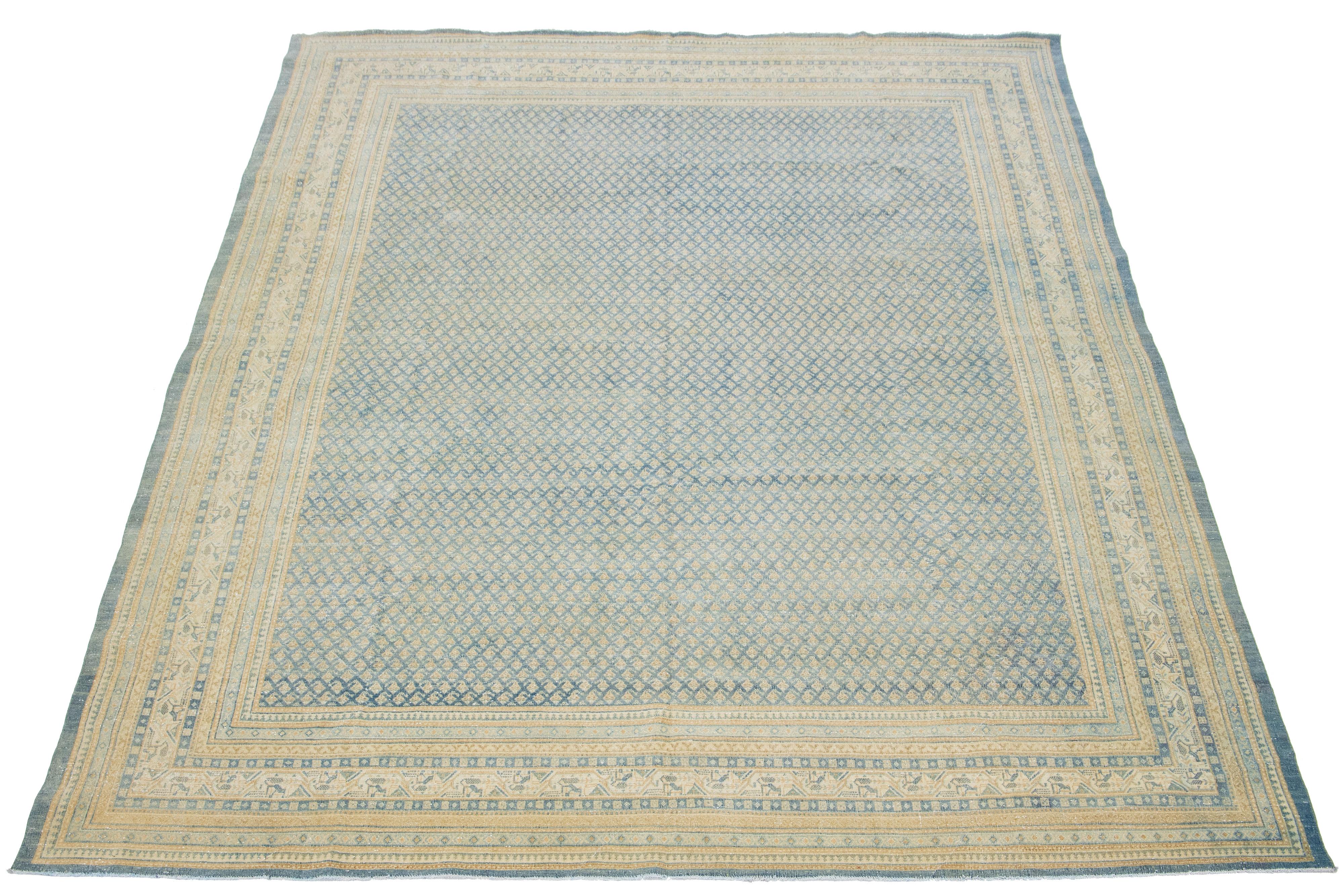 This Persian Tabriz wool rug from the 1920s showcases a handcrafted, traditional allover pattern. The contrasting light blue background and beige colors accentuate the design.

This rug measures 8'9' x 11'10
