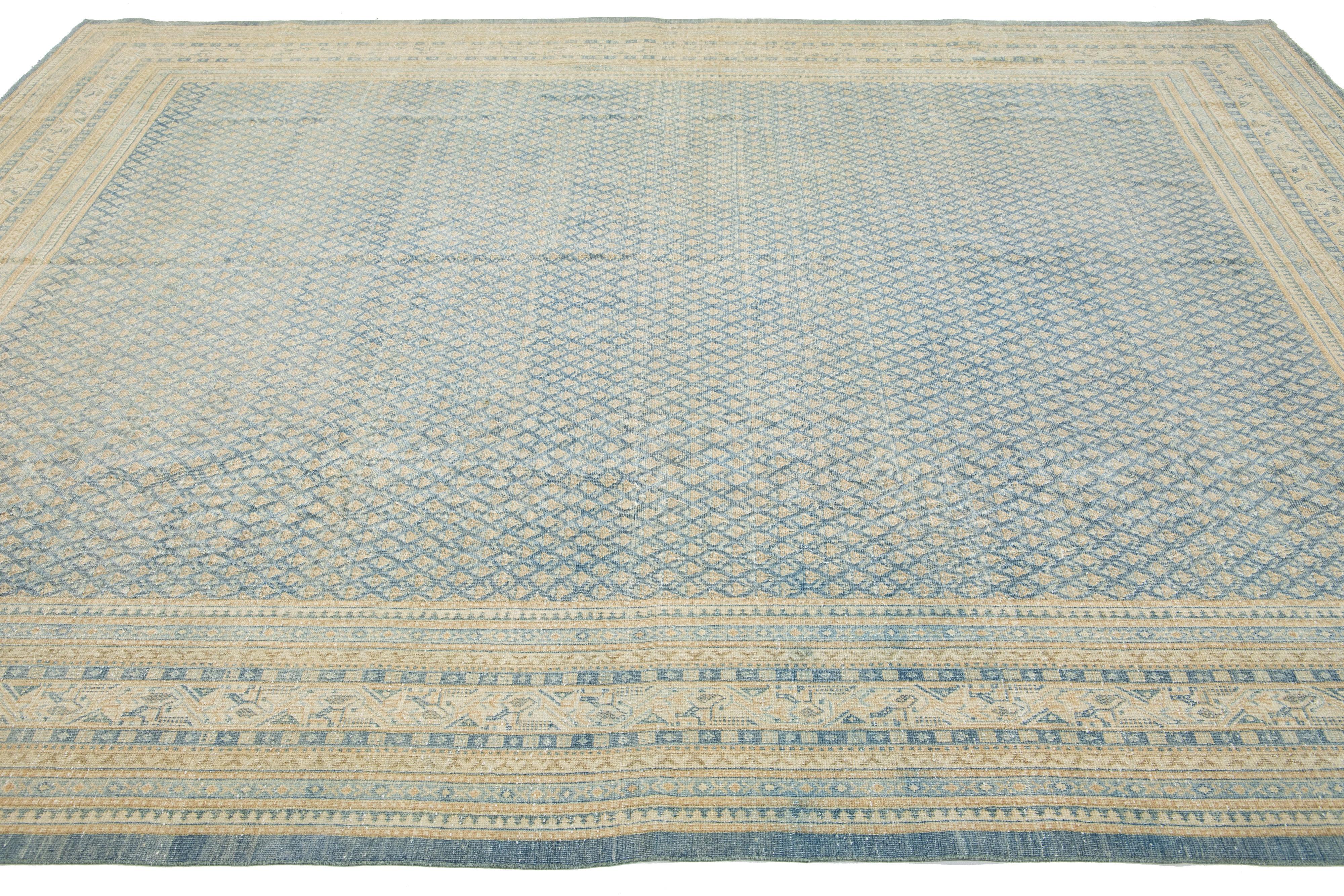 20th Century Handmade Antique Persian Tabriz Wool Rug Featuring a Blue and Beige Pattern For Sale