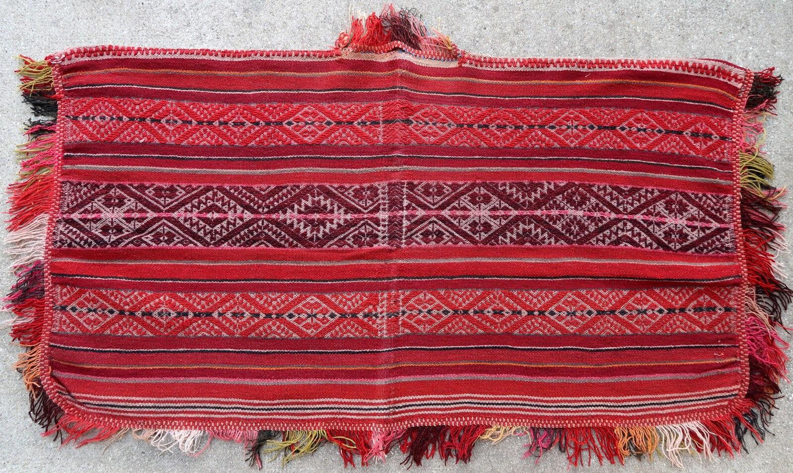 Antique poncho from Peru made from Kilim. It is from the beginning of 20th century in original good condition.

- Condition: original good,

- circa 1900s,

- Size: 2' x 3.9' (64cm x 120cm),

- Material: Wool,

- Country of origin: