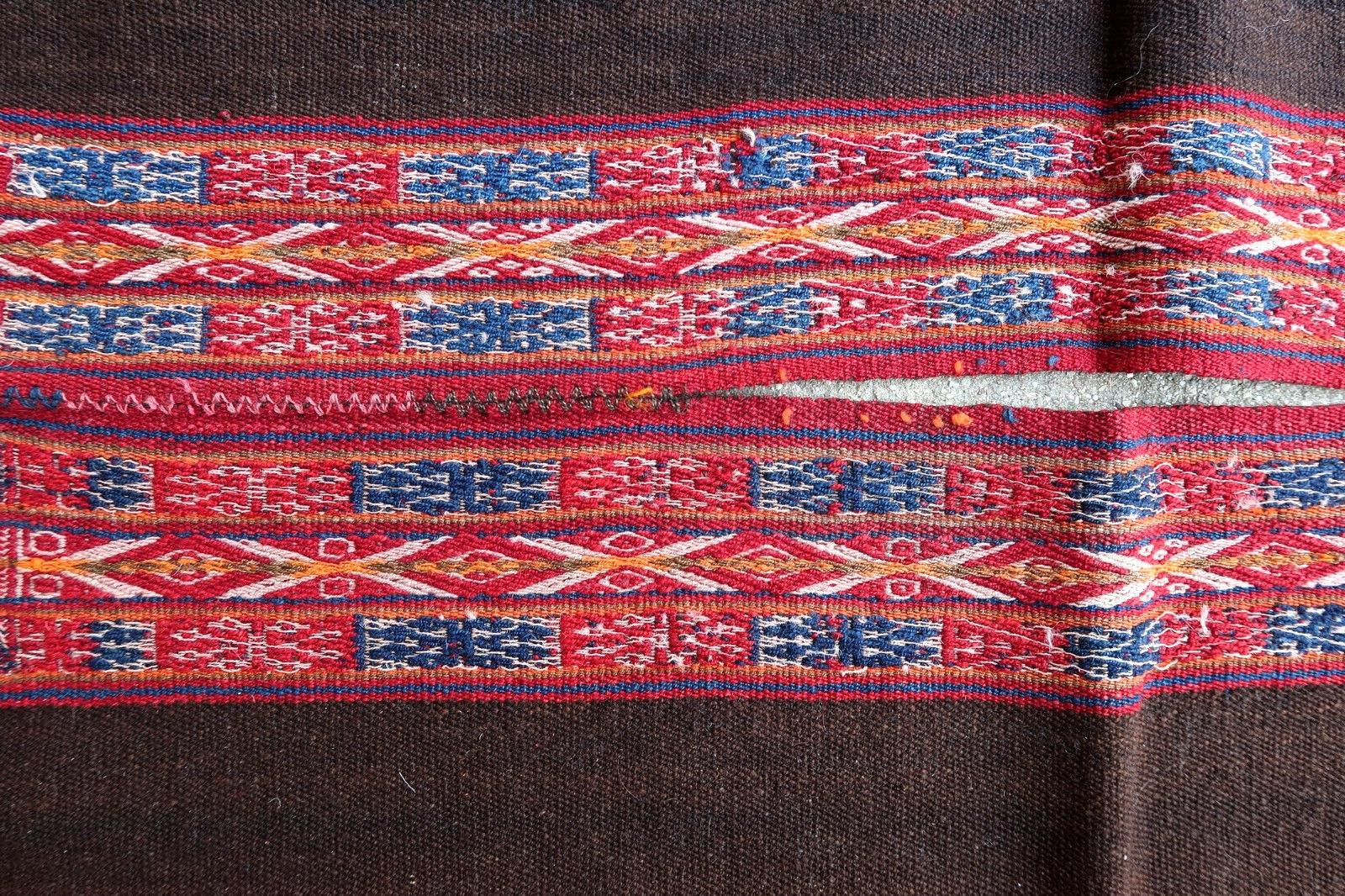 Antique poncho from Peru made from Kilim. It is from the beginning of 20th century in original good condition.

- Condition: Original good,

- circa 1900s,

- Size: 2.9' x 3.3' (90cm x 101cm),

- Material: Wool,

- Country of origin: