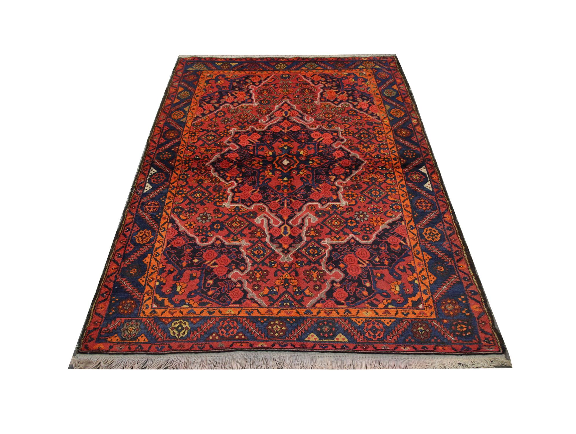 Handmade carpet with rich orange and red colors cover this high-quality Antique Karabagh rug. Hand-woven in 1950 with hand-spun, vegetable-dyed wool, and cotton, by some of the finest Caucasian artisans. This exquisite area rug features a highly