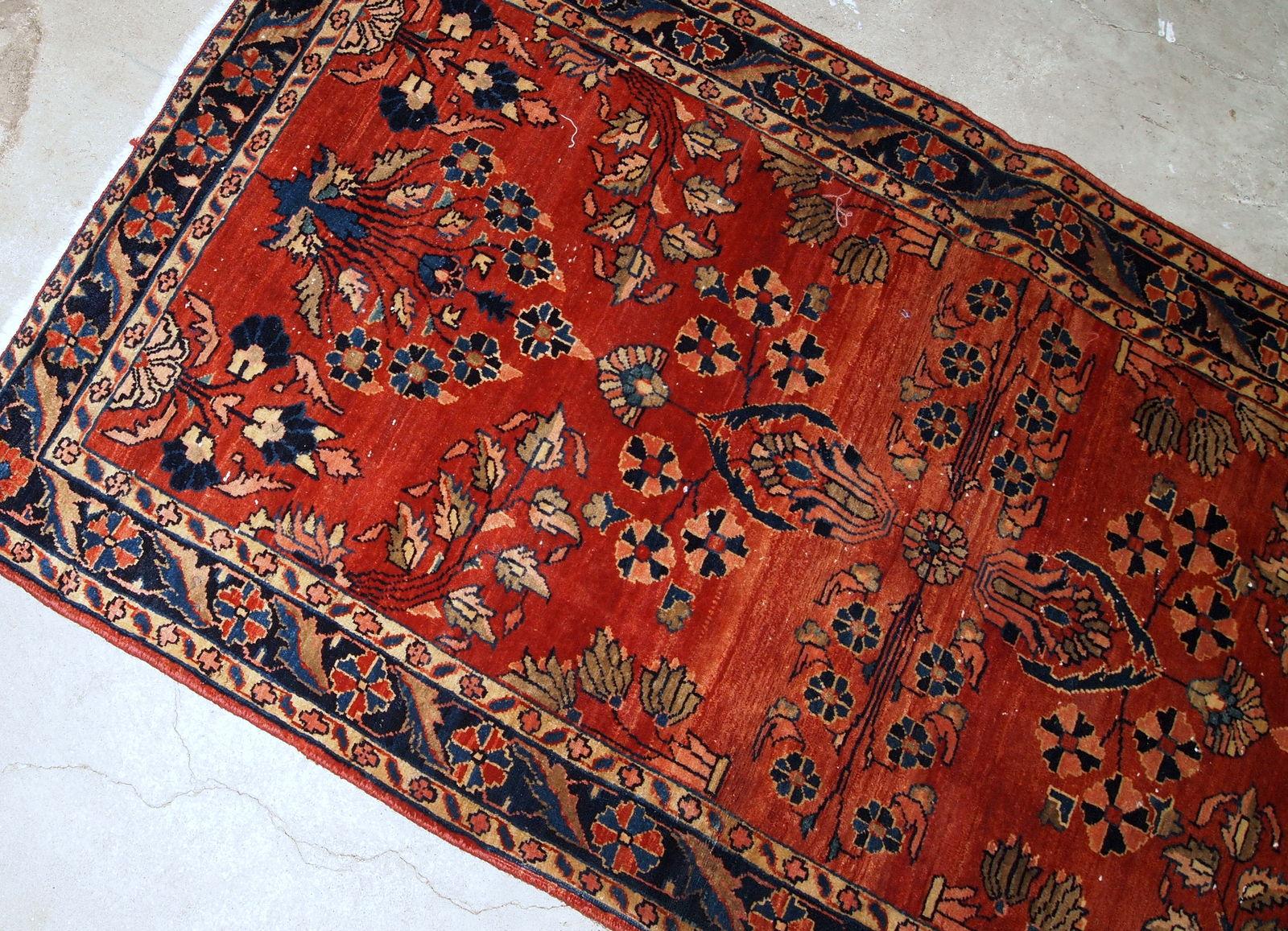 Handmade antique Sarouk Mahajeran style rug in original good condition. The rug is from the beginning of 20th century made in bright red wool.

- Condition: original good,

- circa 1900s,

- Size: 2.5' x 5.6' (76cm x 170cm),

- Material: