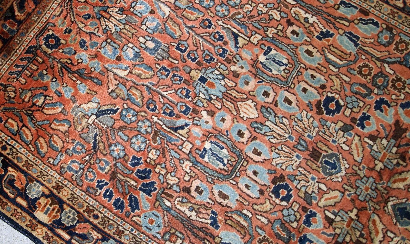 Hand-weaved antique Sarouk rug from the beginning of 20th century. The rug is in original good condition, made in Classic floral design in red and sky blue shades.

- Condition: original good,

- circa: 1920s,

- Size: 3.4' x 5.4' (103cm x