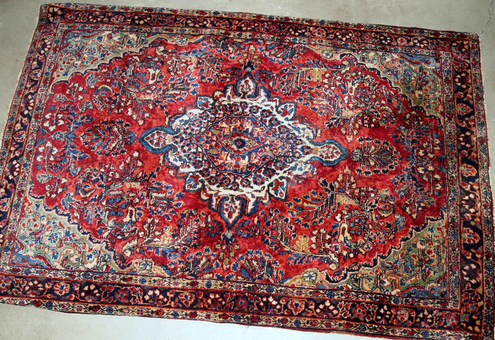 Handmade antique Sarouk rug in red color. The rug is from the beginning of 20th century in original good condition.

-Condition: original good,

-circa: 1920s,

-Size: 3.10' x 5.4' (119cm x 164cm),

-Material: wool,

-Country of origin: