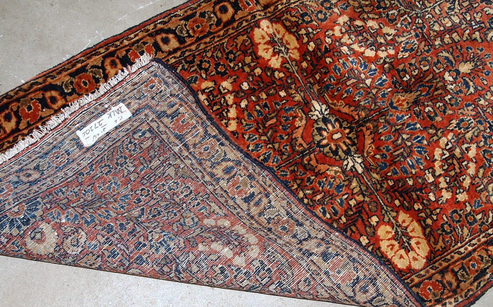 Handmade antique Sarouk style rug in original good condition. The rug is from the beginning of 20th century made in red wool.

- Condition: original good,

- circa 1920s,

- Size: 2.4' x 5.3' (73cm x 161cm),

- Material: wool,

- Country
