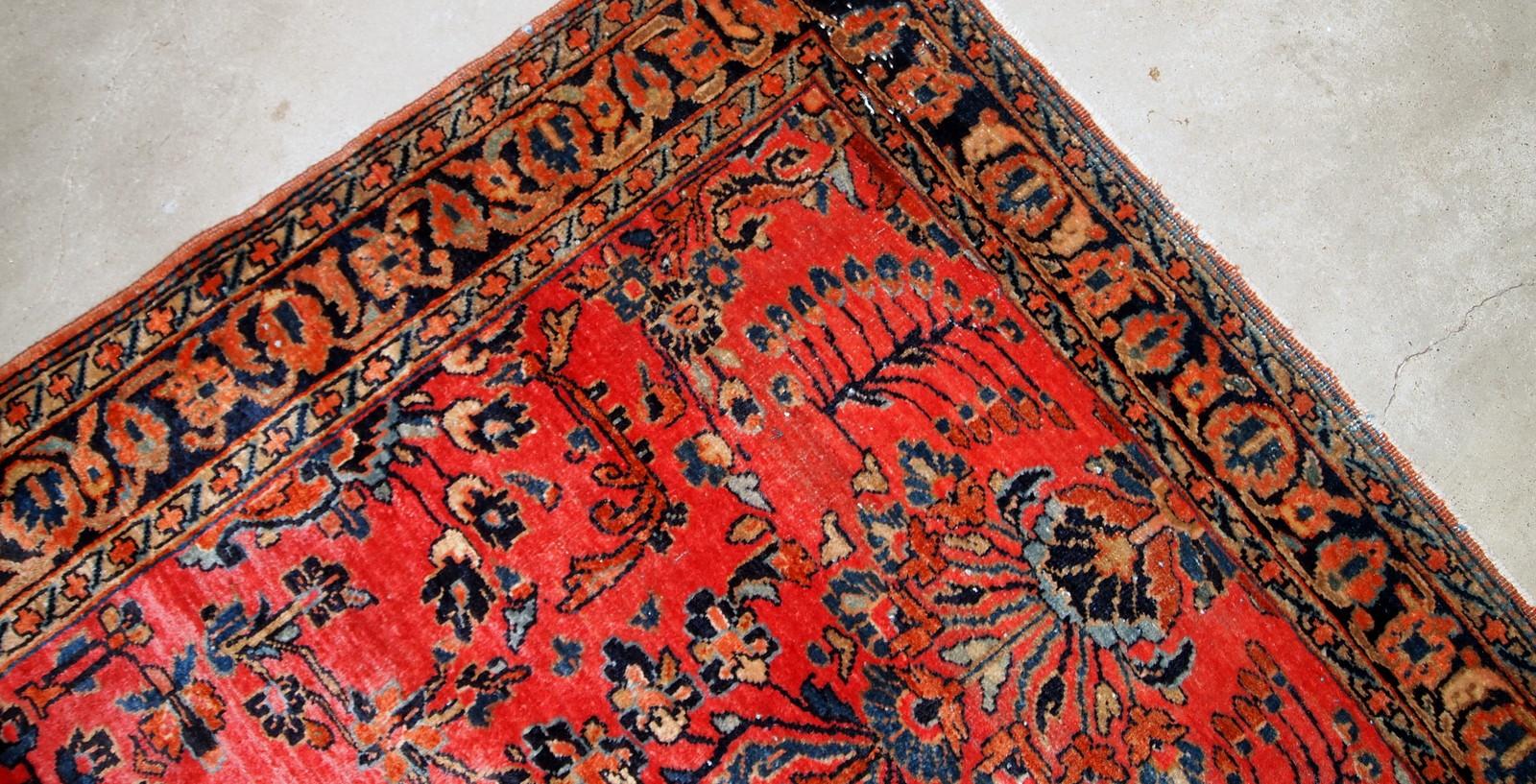 Handmade antique Sarouk style rug in original condition, it has some signs of age. The rug is from the beginning of 20th century made in red wool.

- Condition: Original, some signs of age,

- circa 1920s,

- Size: 3.2' x 5.3' (97cm x